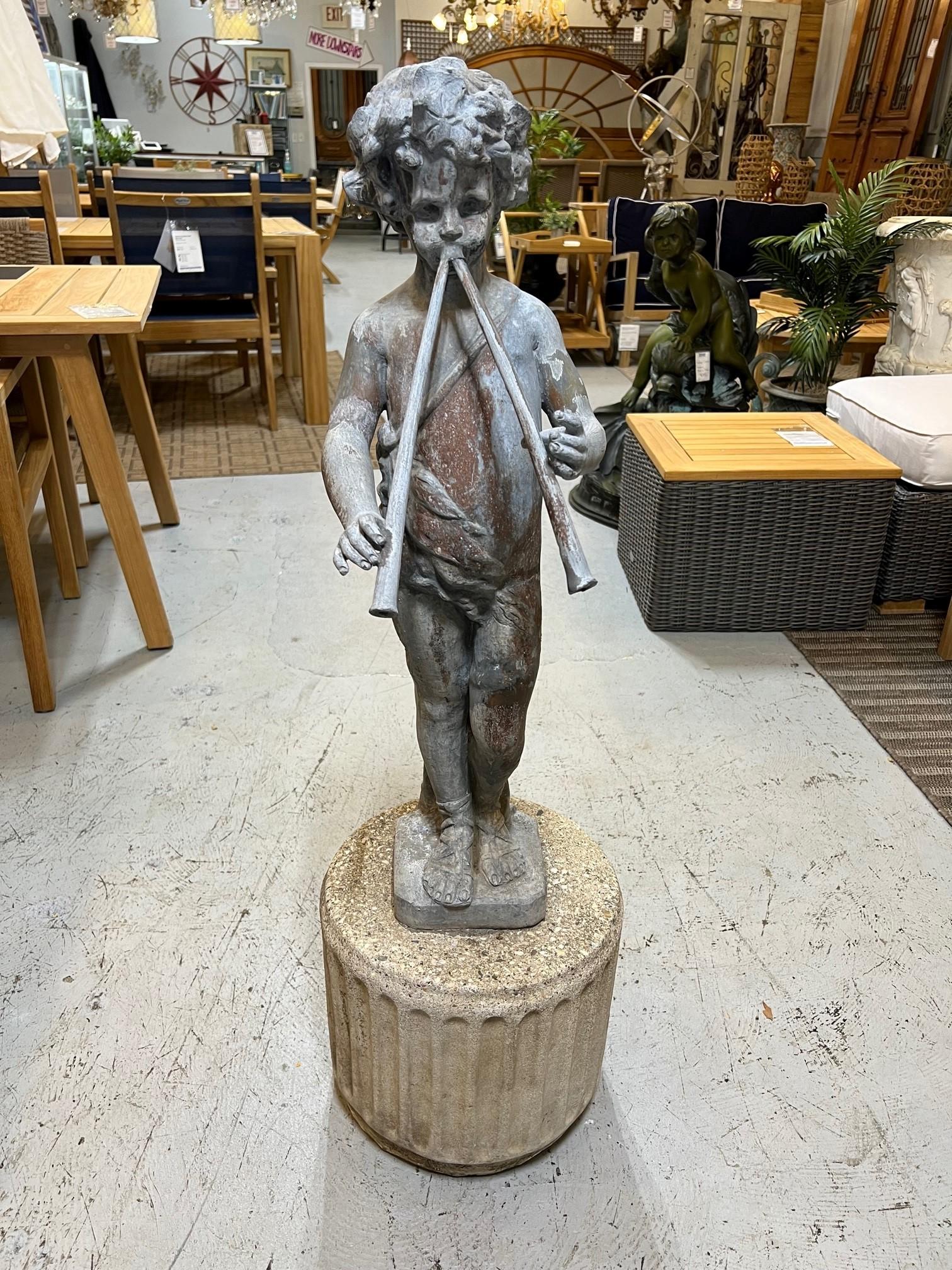 Vintage lead figural statue of musical pan on a stone pedestal with two flutes. This is a very classical piece that would look amazing in a garden or on a patio. I believe it came from England where many lead statues were made and shipped to the