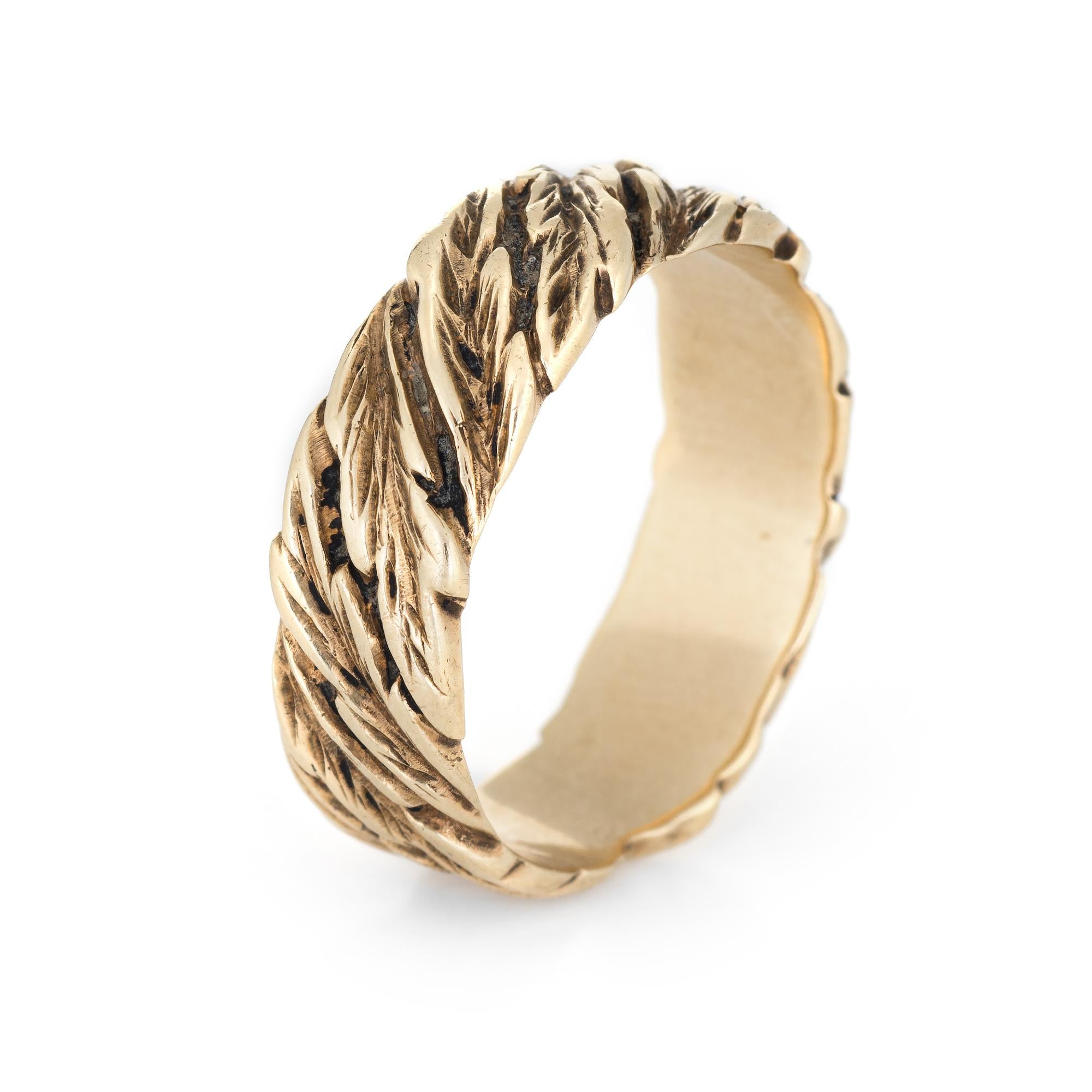 Finely detailed vintage band (circa 1950s to 1960s), crafted in 14 karat yellow gold. 

The ring epitomizes vintage charm and would make a lovely alternative wedding band. The band features a scrolled pattern of leaves that extend around the entire