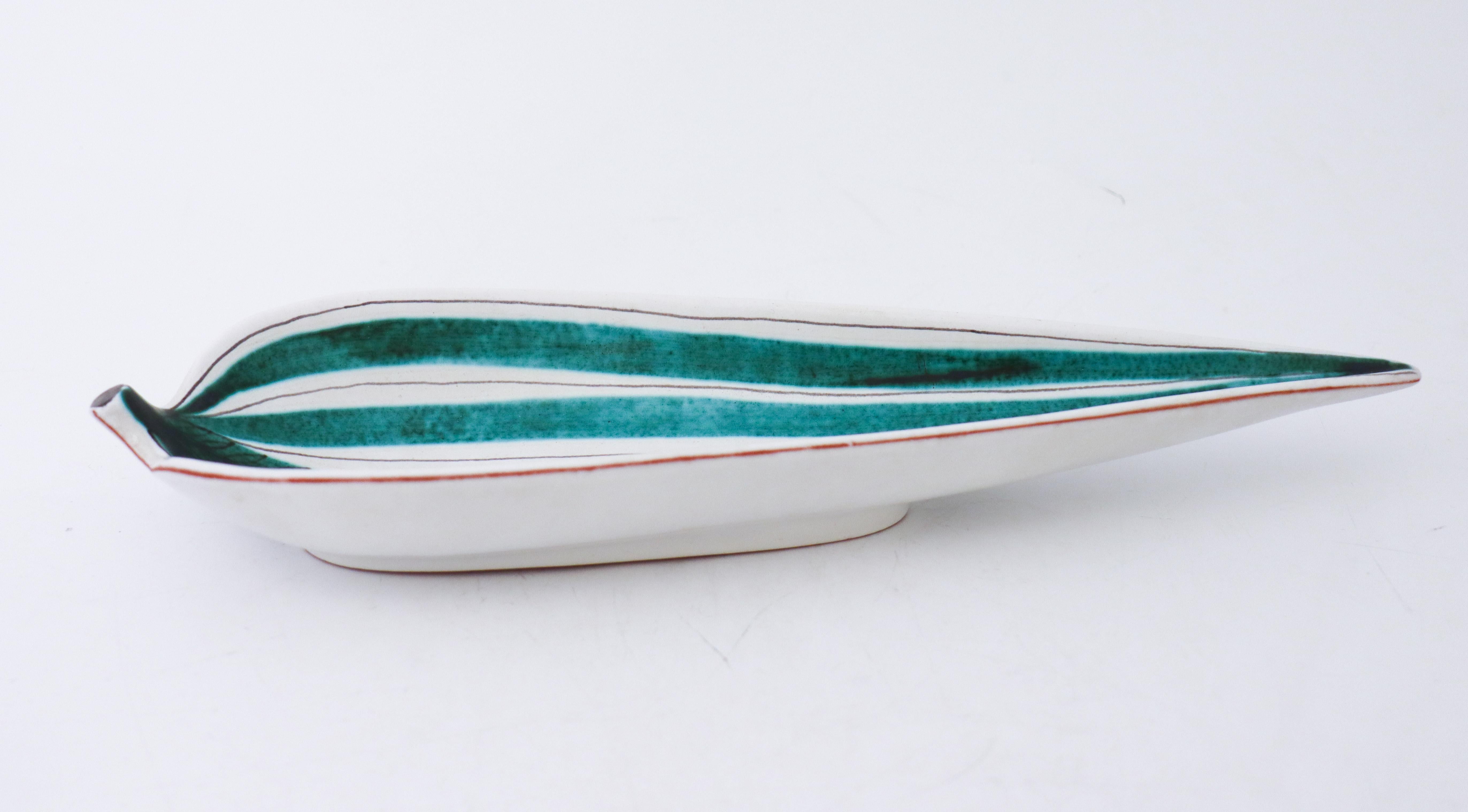 A serving dish in faience designed by Stig Lindberg at Gustavsbergs Studio in Stockholm, it is 31.5 x 10.5 cm (12.6