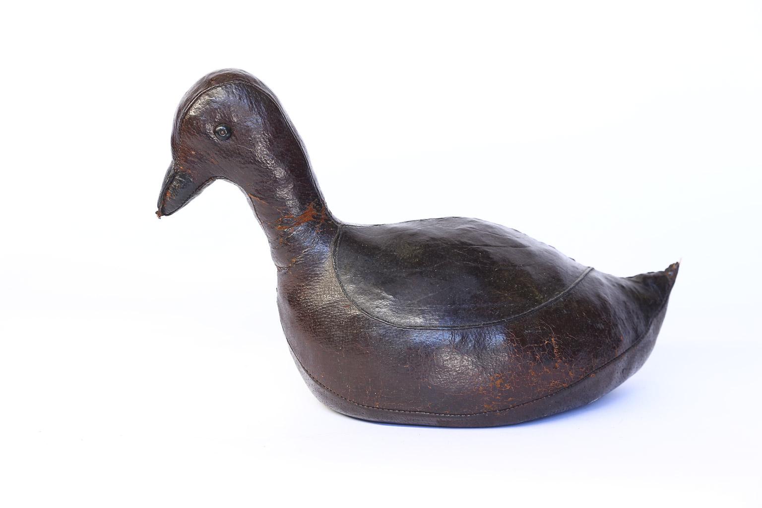 This is a beautiful leather doorstop by Dimitri Omersa in the shape of a duck. Omersa Co., England, produced several animals as footstools and doorstops for Abercrombie and Fitch. This sweet duck is a wonderful conversation piece and useful as a