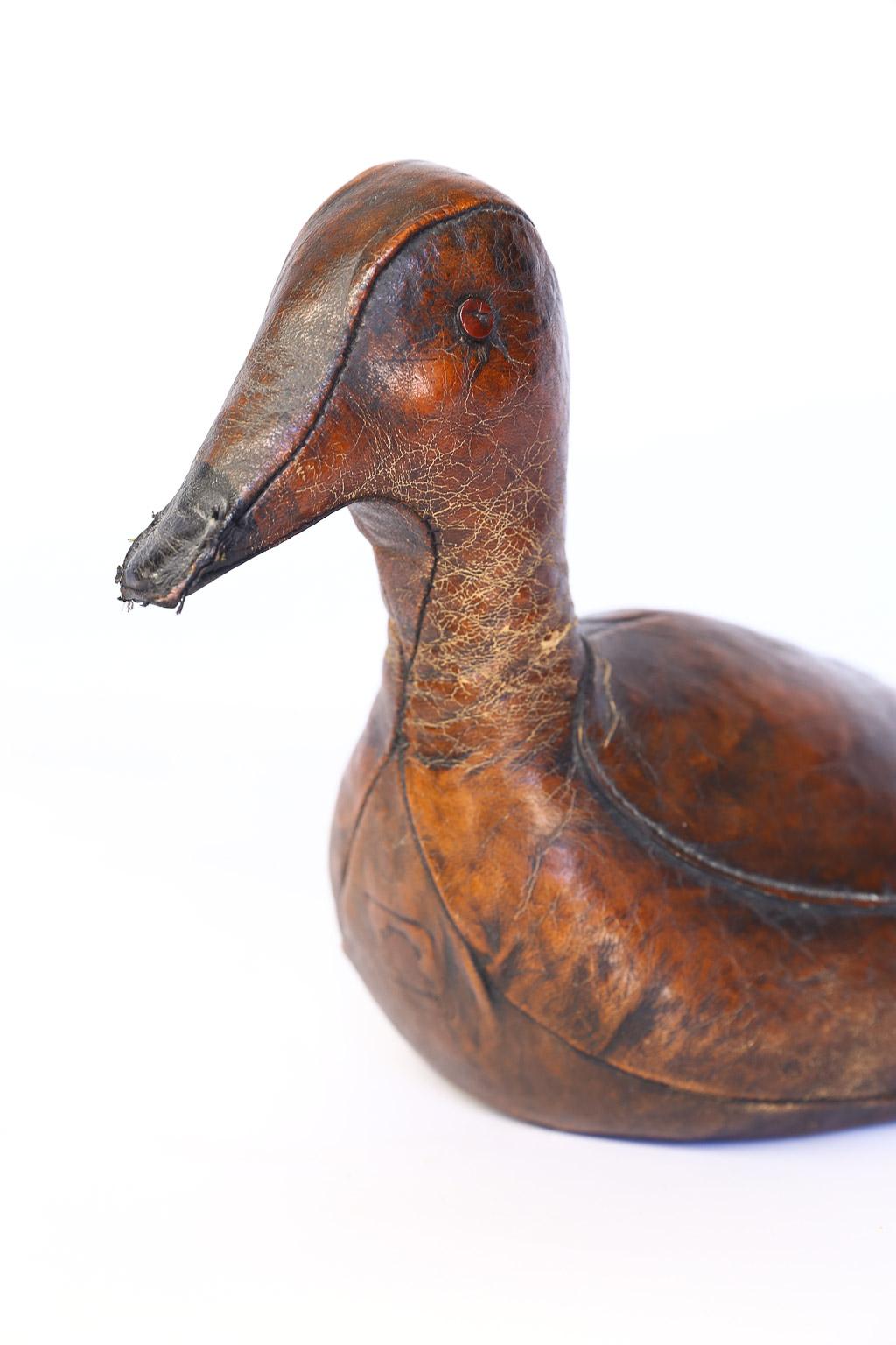 This is a beautiful leather doorstop by Dimitri Omersa in the shape of a duck. Omersa Co., England, produced several animals as footstools and doorstops for Abercrombie and Fitch. This sweet duck is a wonderful conversation piece and useful as a