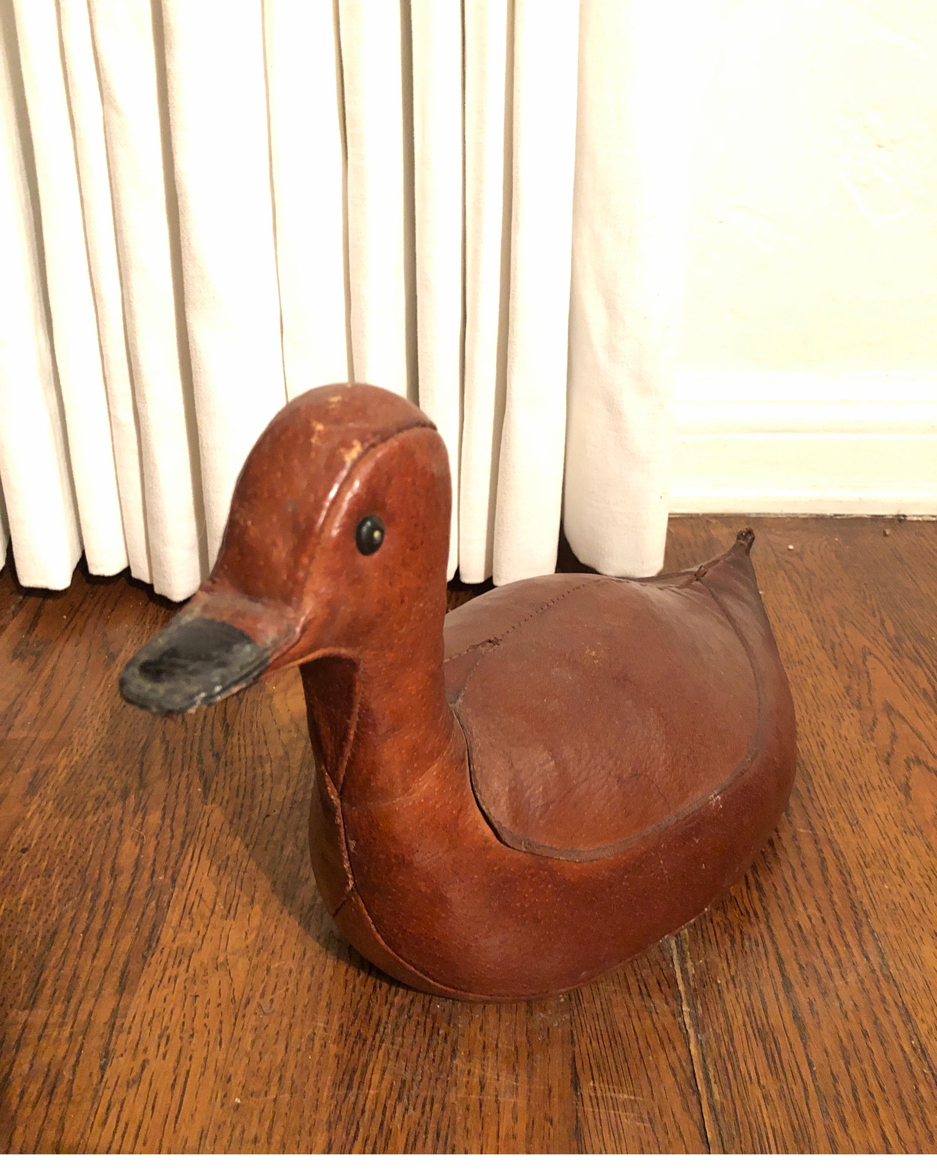 This is a beautiful leather doorstop by Dimitri Omersa in the shape of a duck. Omersa Co., England, produced several animals as footstools and doorstops for Abercrombie and Fitch. This sweet duck is a wonderful conversation piece and useful as a