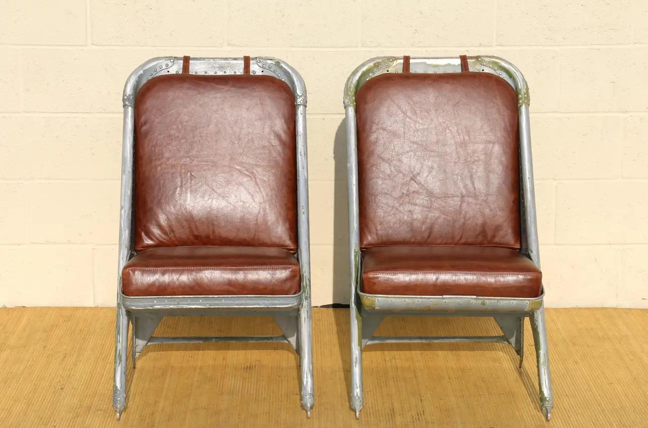 Wonderful pair of airplane chairs made of aluminum, and they have new brown leather seats and backs. They are originally from the 1940’s. The chairs are in good vintage condition. They have no damages. This chairs are absolutely gorgeous and