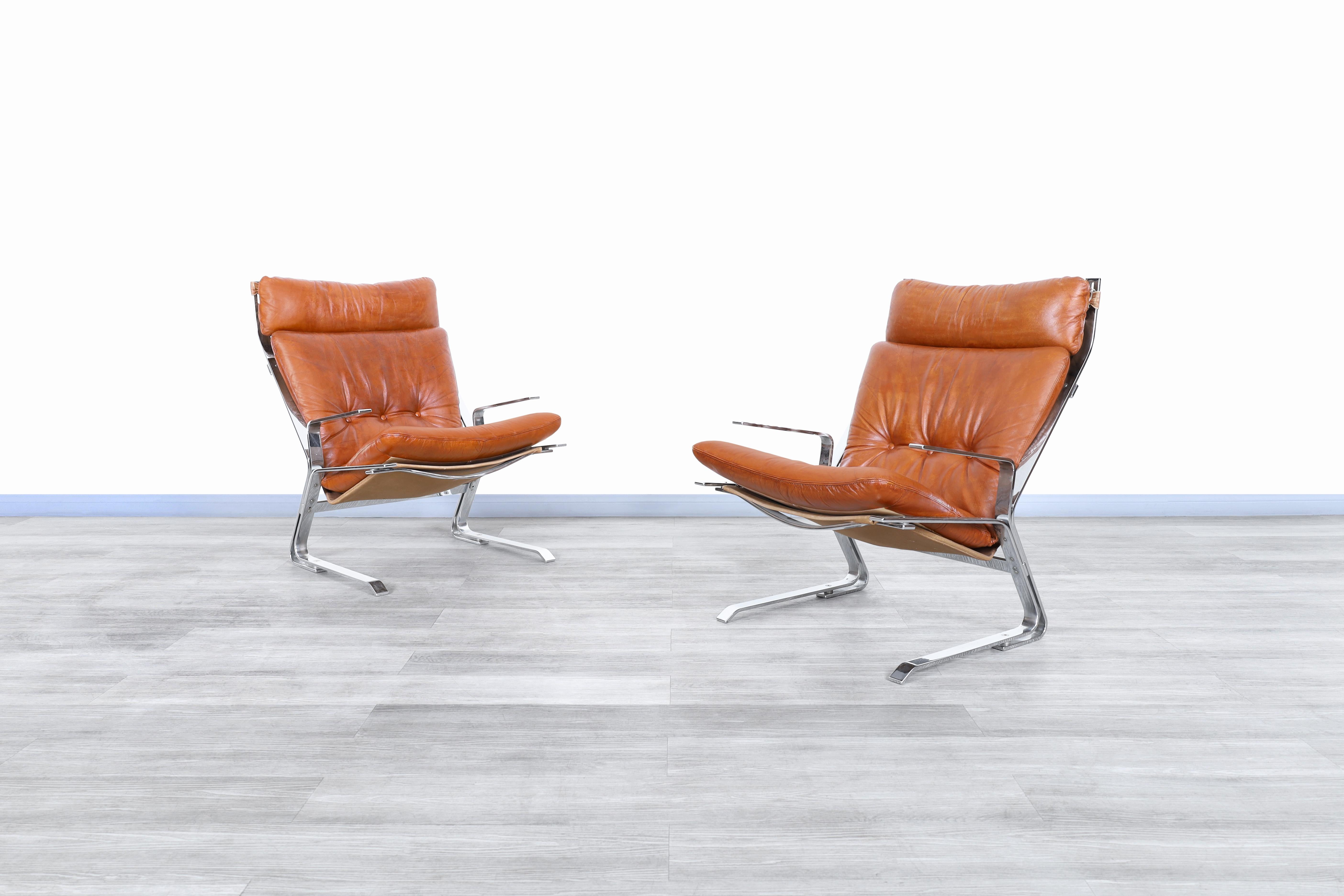 Wonderful vintage leather and chrome “pirate” lounge chairs designed by Elsa and Nordahl Solheim for Rykken and Co. in Norway, circa 1970s. These chairs have a distinctive design and are a great representation of the mid-century era. Each chair has