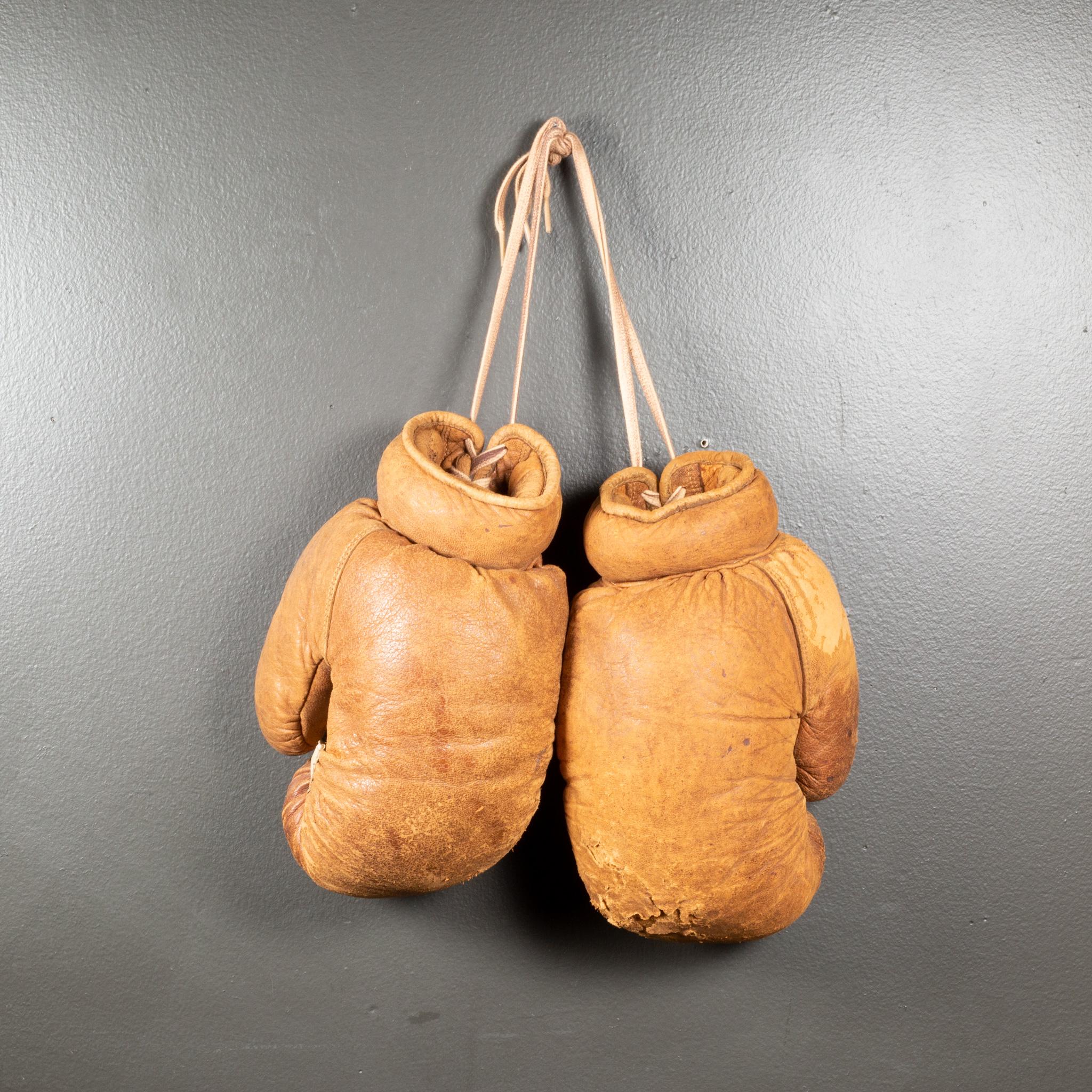 ABOUT

Vintage reddish brown leather boxing gloves filled with horse hair and an extra padding strip on the palms. Vintage repair to one palm padding. The leather is very soft and in good condition.

    CREATOR Unknown. 
    DATE OF MANUFACTURE