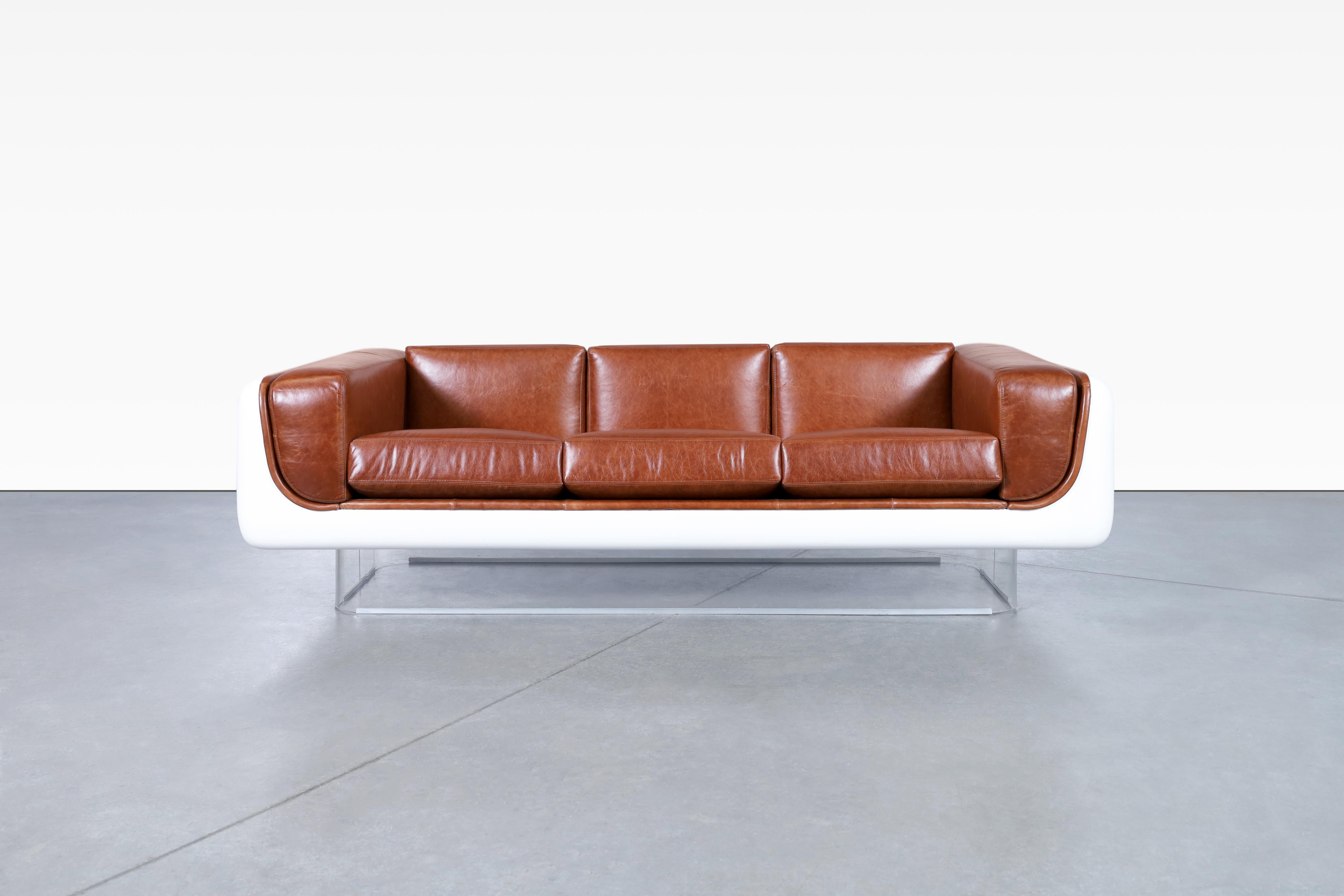 Beautiful vintage leather and lucite sofa designed by William C. Andrus for Steelcase in the United States, circa 1970’s. The newly reupholstered sofa is not just a stunning piece of furniture, it is a work of art that will take your breath away.