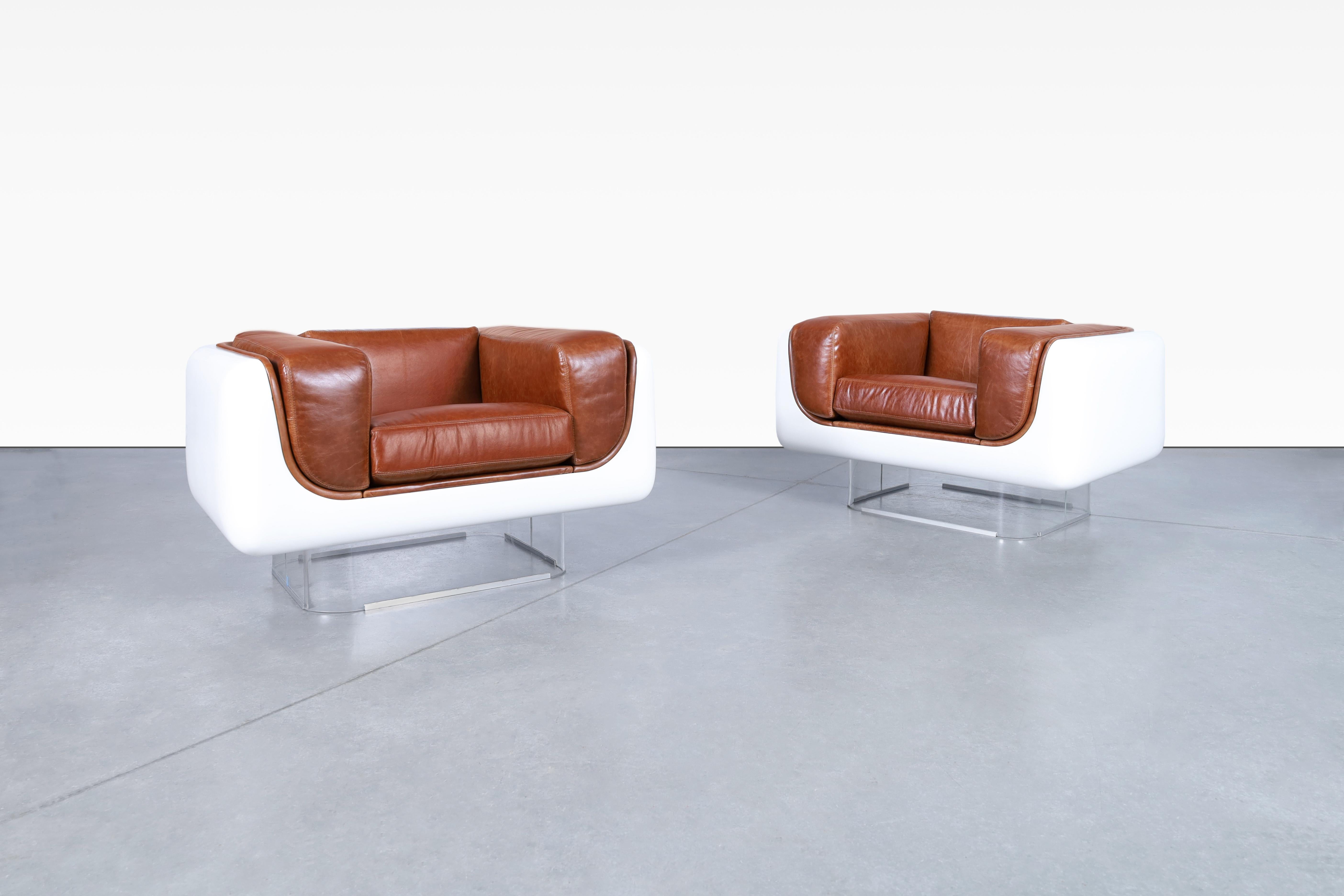 Wonderful vintage leather and lucite lounge chairs designed by William C. Andrus for Steelcase in the United States, circa 1970’s. The newly reupholstered chairs are truly a sight to behold. They are not just stunning pieces of furniture but works