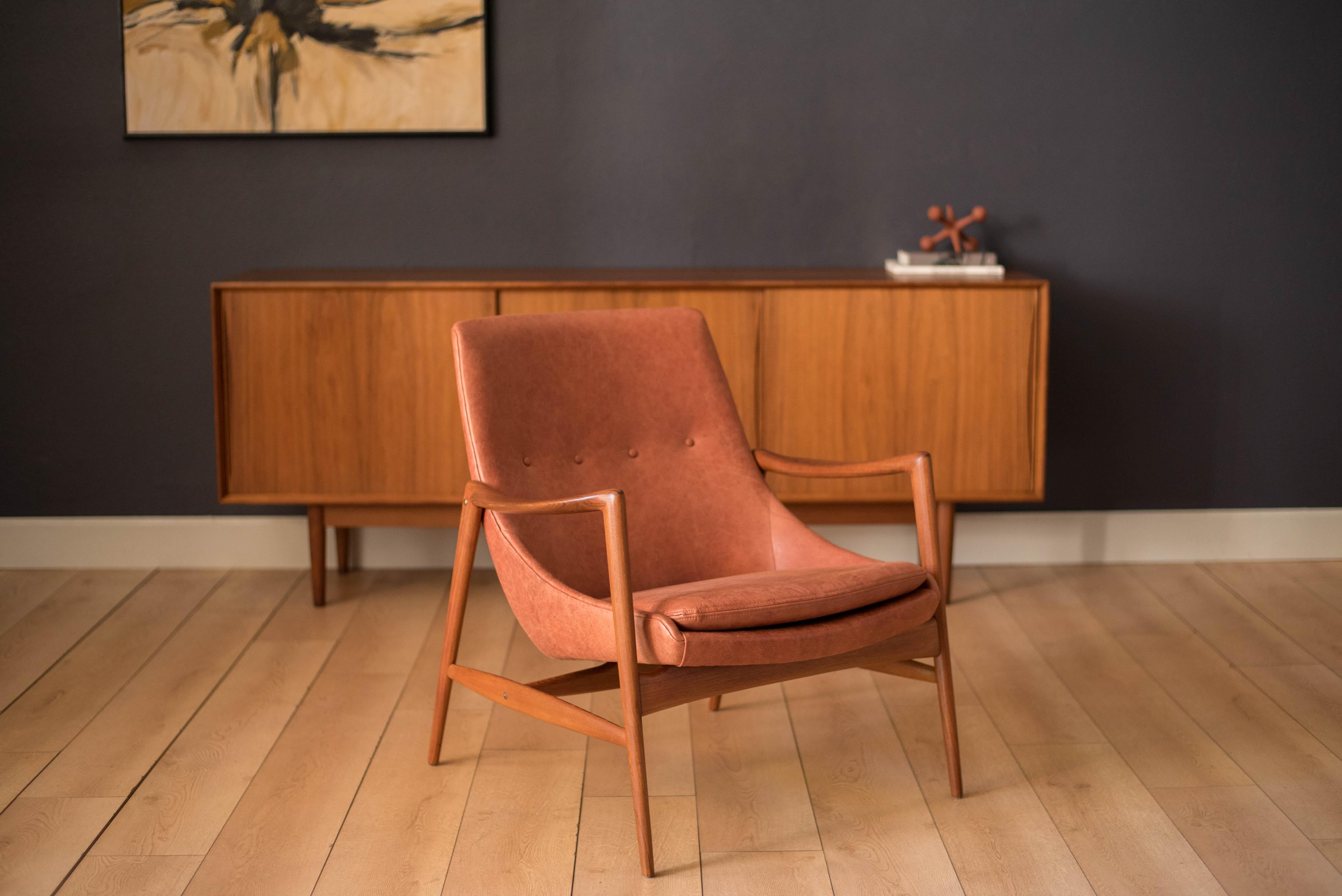 Mid-Century Modern easy armchair designed by Rolf Rastad & Adolf Relling for Dokka Möbler, circa 1950s. This piece features a sculptural teak frame and has been newly reupholstered in a natural camel tone leather.