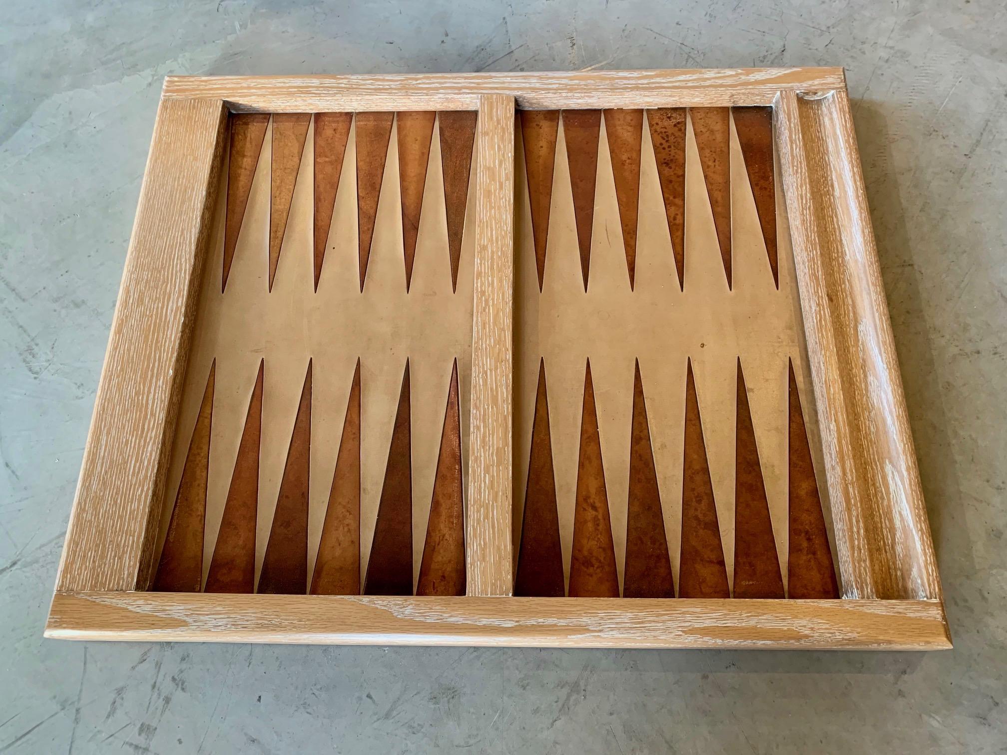 Stunning vintage backgammon board refinished in cerused oak. Game play area is made up of tan leather, with saddle leather triangles. Excellent vintage condition. Very substantial and heavy board.