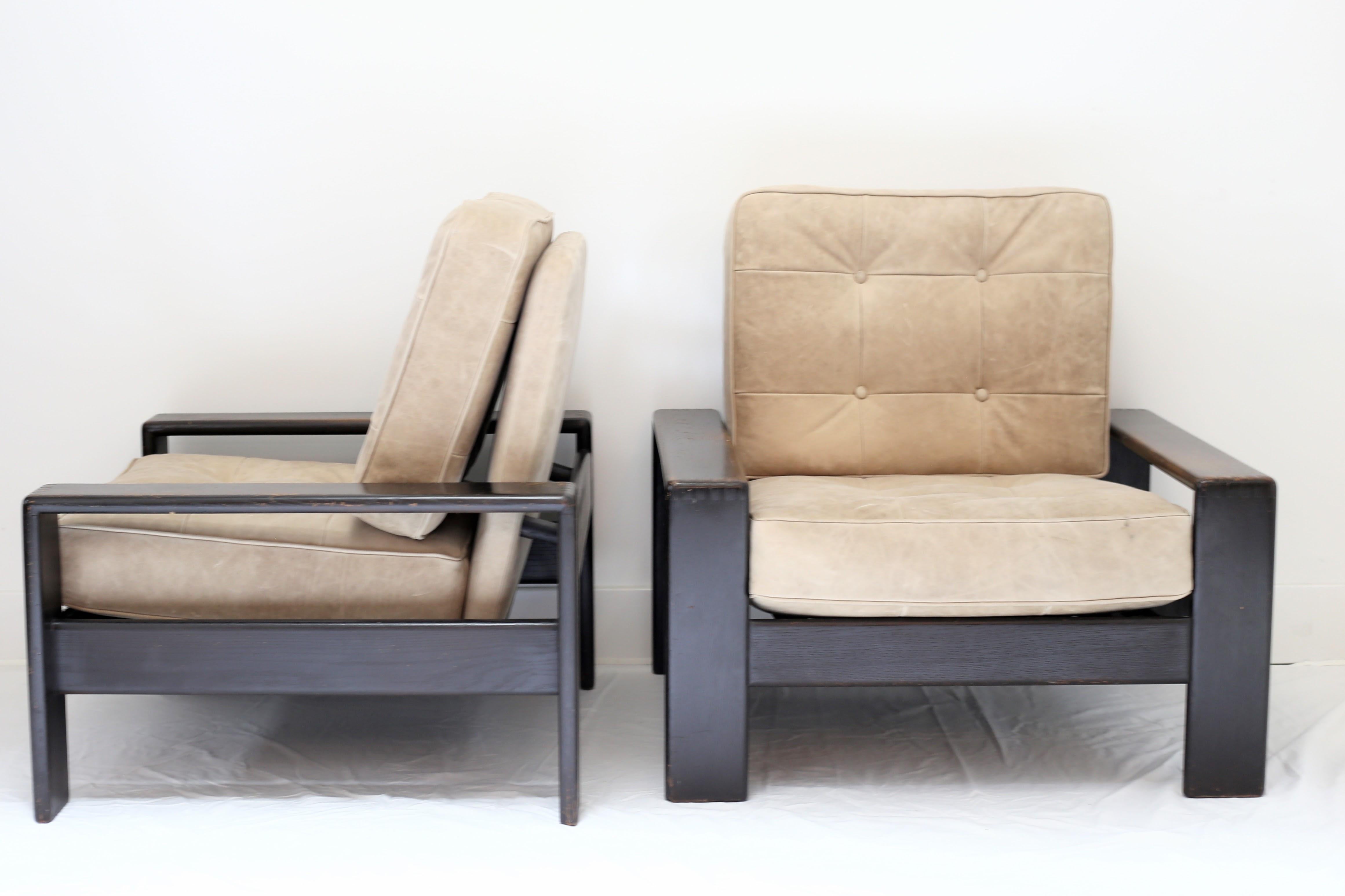 Pair of handsome vintage wood lounge chairs with button tufted box cushions, newly reupholstered in Moore & Giles Leather.
