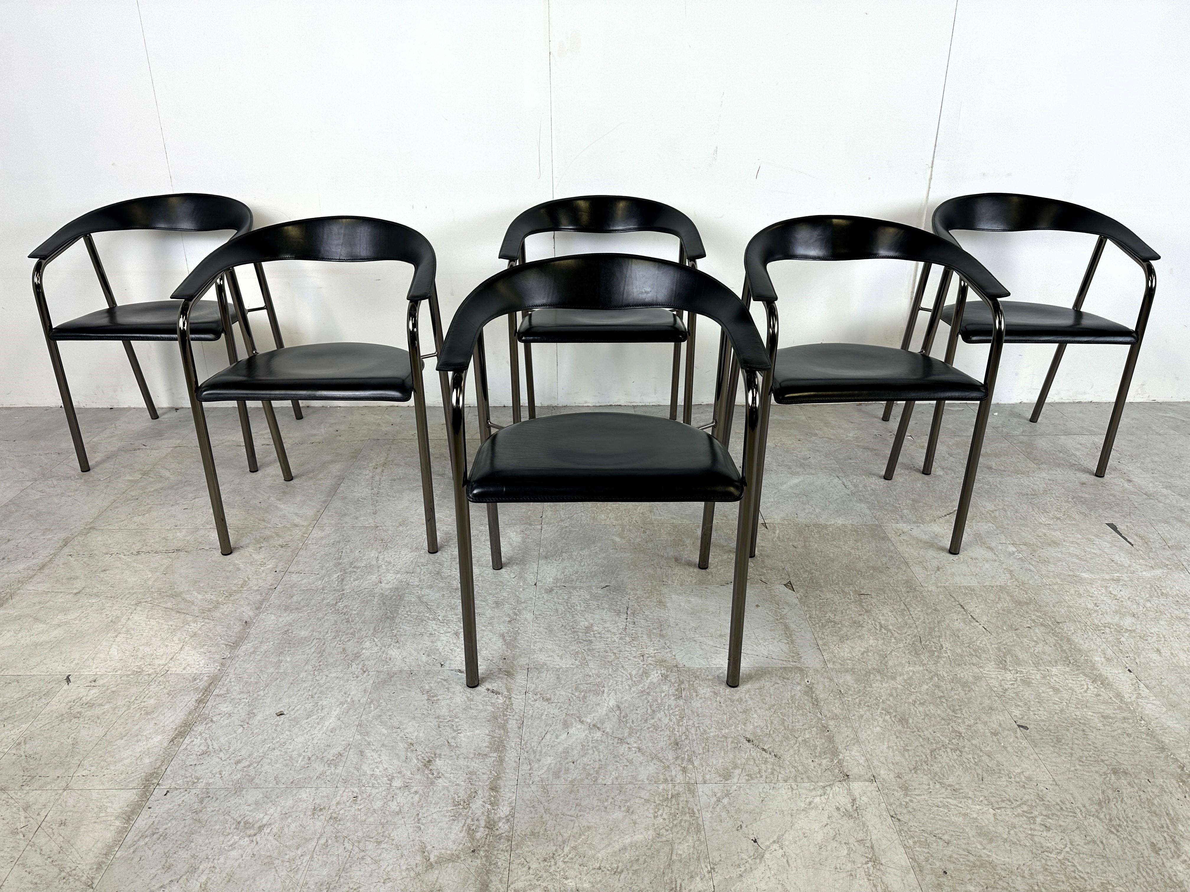 Set of 6 black leather armchairs by Arrben Italy.

Beautiful curved backrests forming the armrests in leather, with leather seats and a black metal frame.

The chairs are stamped underneath the seats with 'Arrben Italy'.

Very good condition

1980s