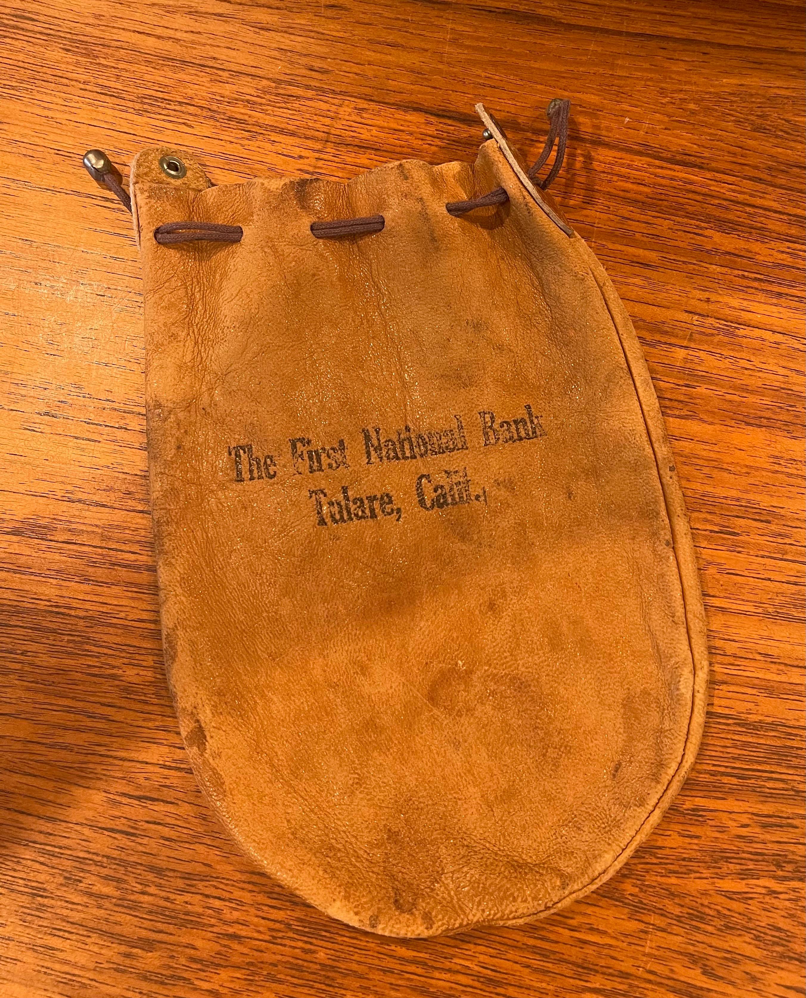 Vintage leather bank / money bag from The First National Bank- Tulare, Calif., circa 1930s. The bag is in very good vintage condition and measures 6