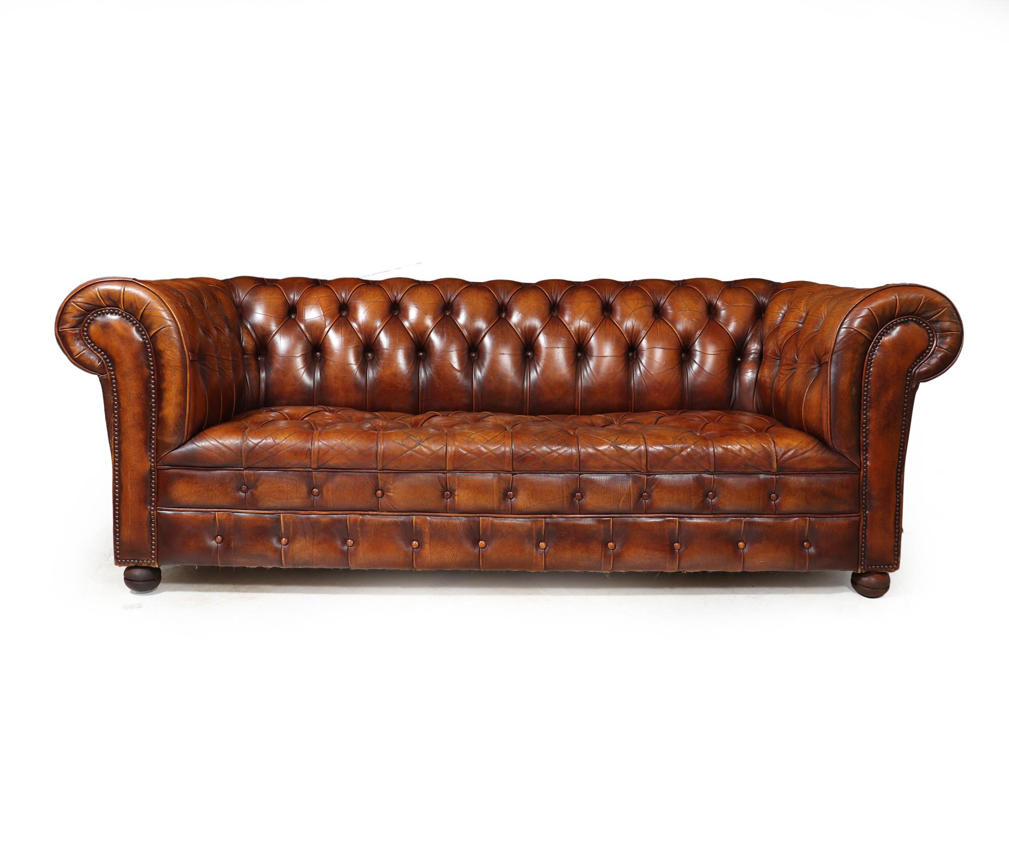 VINTAGE CHESTERFIELD SOFA
A timeless piece of furniture - an authentic and elegant English vintage leather button seated hand dyed Chesterfield sofa, meticulously crafted back in the 1960s. The rich tan brown leather exudes classic charm,