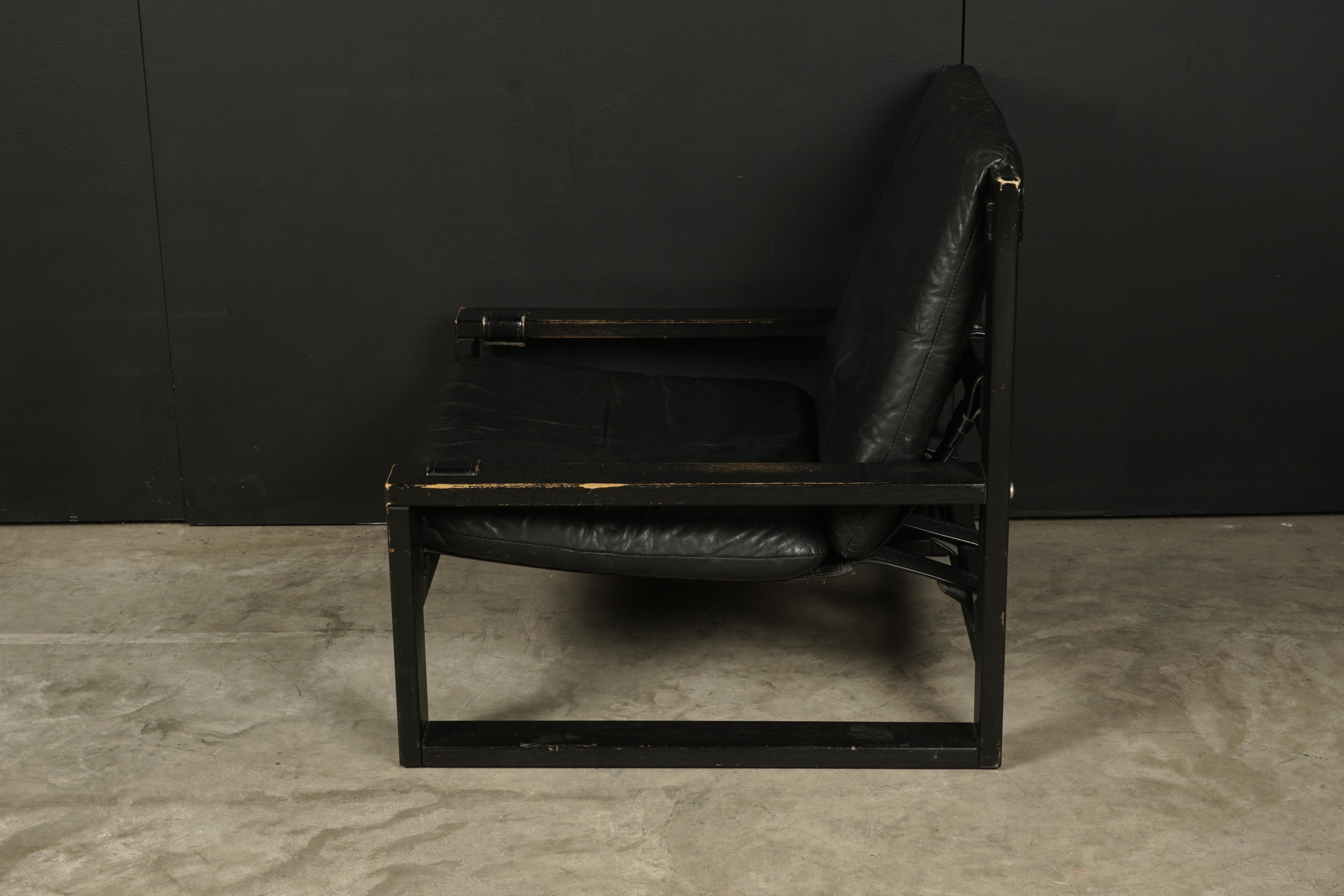 Vintage leather chair designed by Sonja Wasseur, Netherlands, 1970s. Black lacquered wooden frames with original black leather cushions.