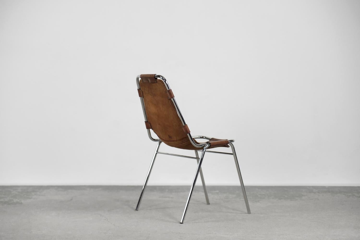 This Les Arcs chair was designed and manufactured by Dal Vera, and chosen by Charlotte Perriand for the alpine resort of Les Arcs in the Tarentaise Valley during the 1960s. The frame is made of chrome metal. The seat with the backrest is made of