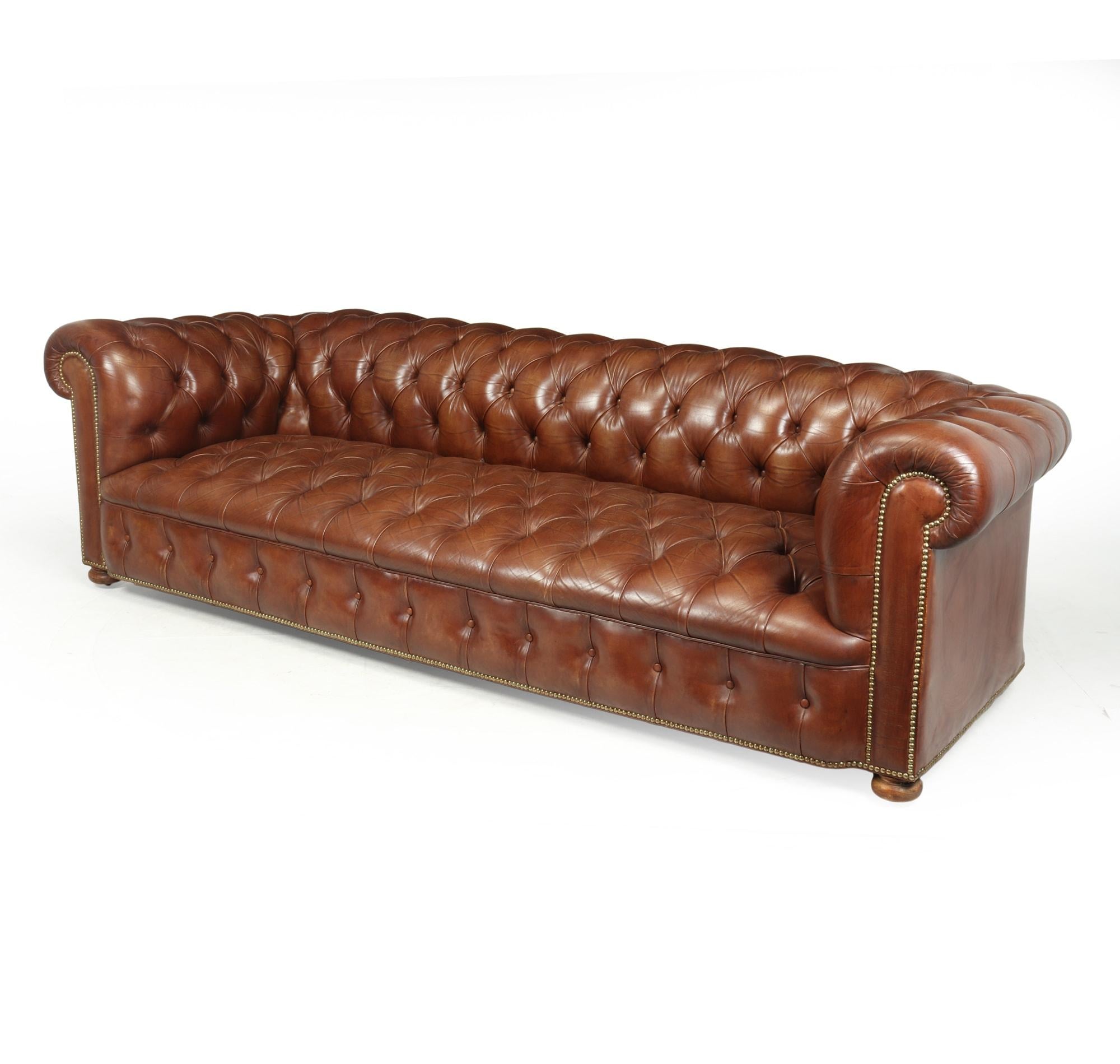 A Large vintage brown leather chesterfield sofa, coil sprung back arms and seat, fully deep buttoned seat and back in excellent condition with no rips tears or old repairs lovely patina to the leather with brass studded detail. Solid hardwood frame