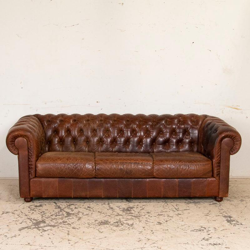 To find an original vintage leather Chesterfield sofa in good condition today is a great find on its own, but to get the complete set with pair of club chairs included makes this a tremendous find that does not come along often. The warm brown