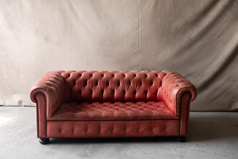 Vintage red leather chesterfield sofa with buttoned seats and back.  Leather with fantastic patina and use.  Great vintage condition.   

We don't have the time to write an extensive description on each of our pieces. We prefer to speak directly