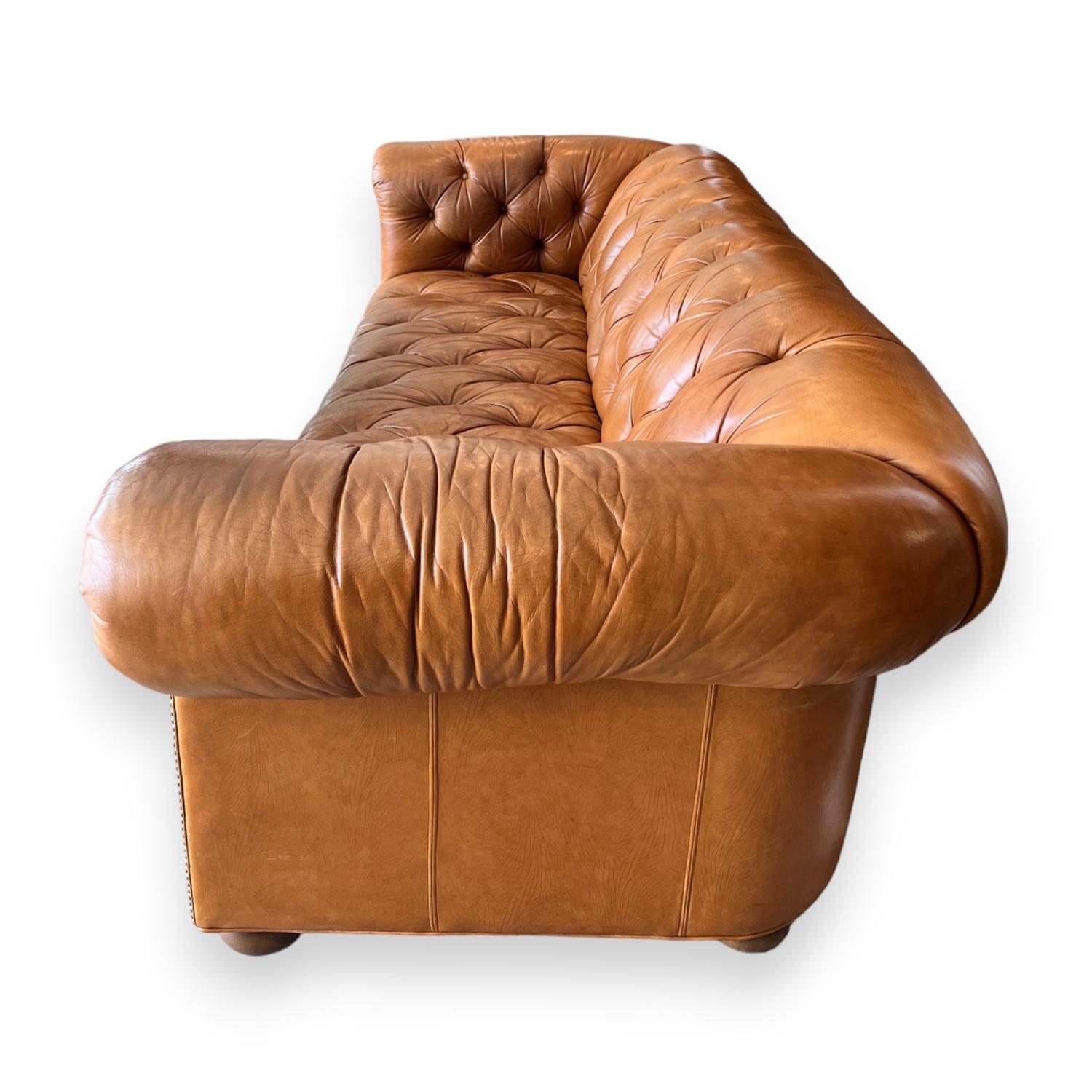 The Chesterfield is a classic design staple, with tufted leather upholstery and rolled arms - this piece is timeless. The leather on this piece is softly aged but in great condition.