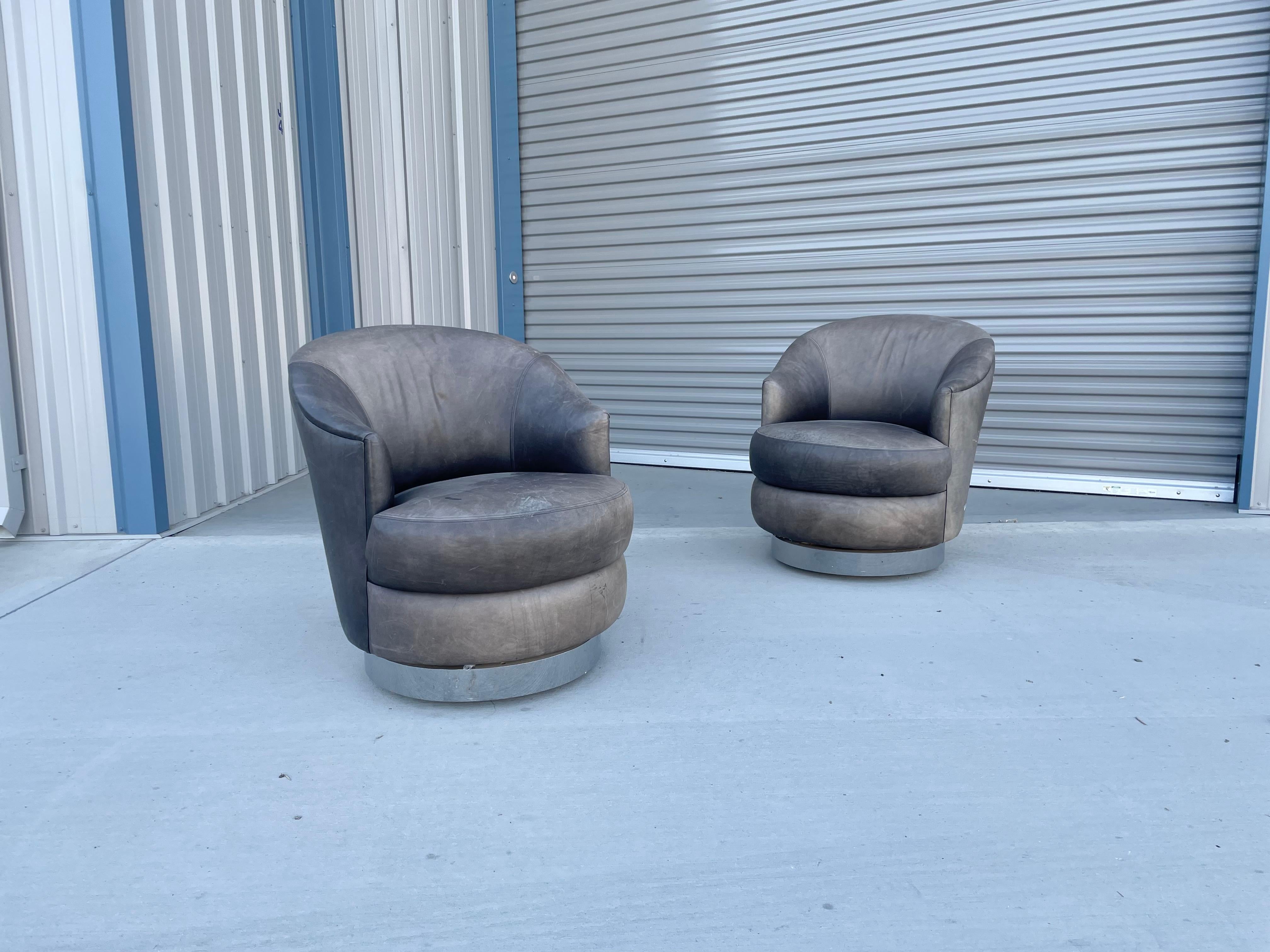 Beautiful pair of vintage leather chrome swivel chairs designed by Sally Sirkin Lewis for J Robert Scott & Associates in the United States, circa 1980s. These chairs are covered in leather upholstery on top of a chrome swivel base that rotates 360