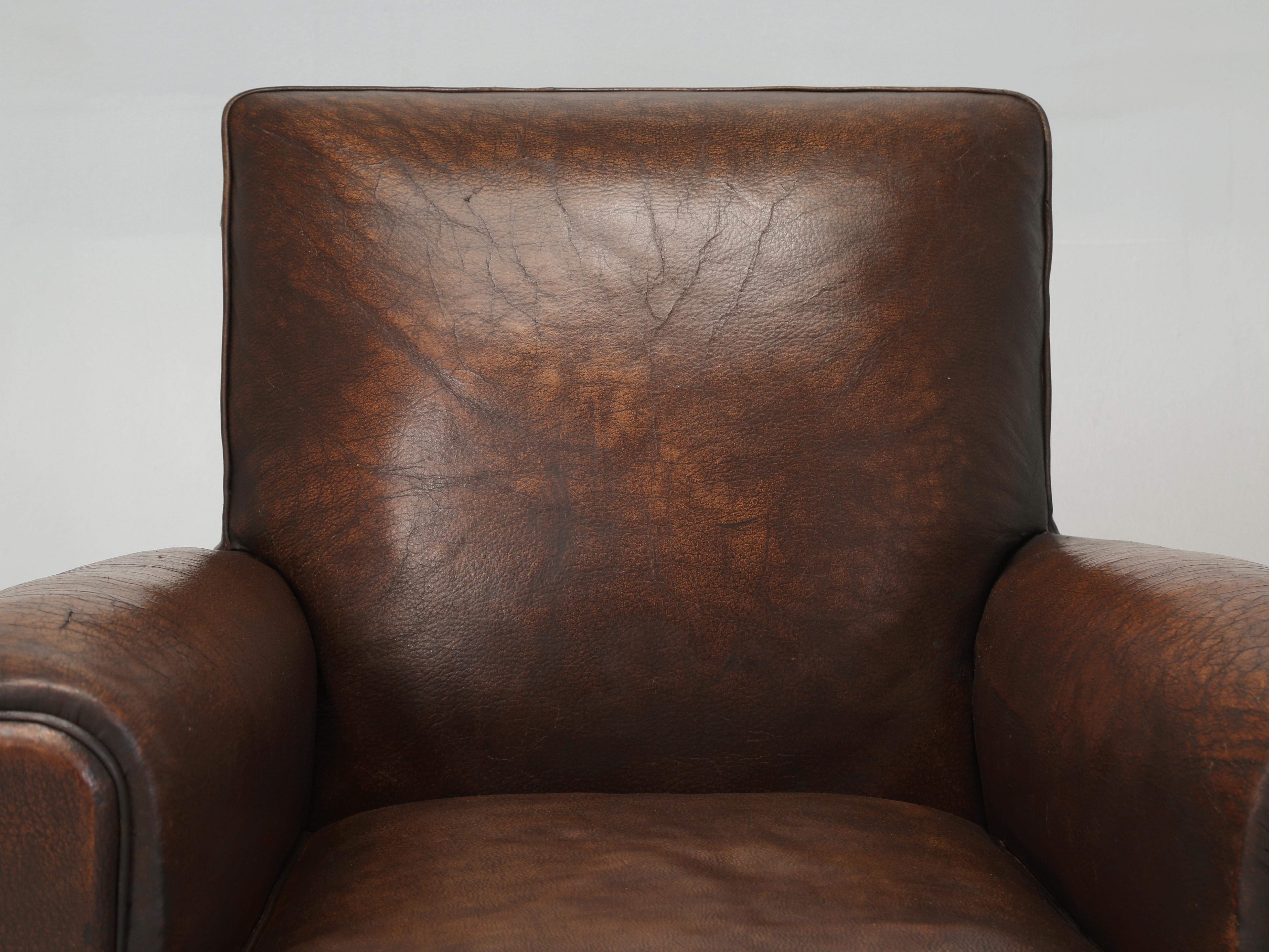 Vintage Leather Club Chair that our Old Plank Upholstery Department restored from the inside out, while leaving the Original Leather unrestored. One might call this a conservation process, rather than a restoration. Our main objective was to make