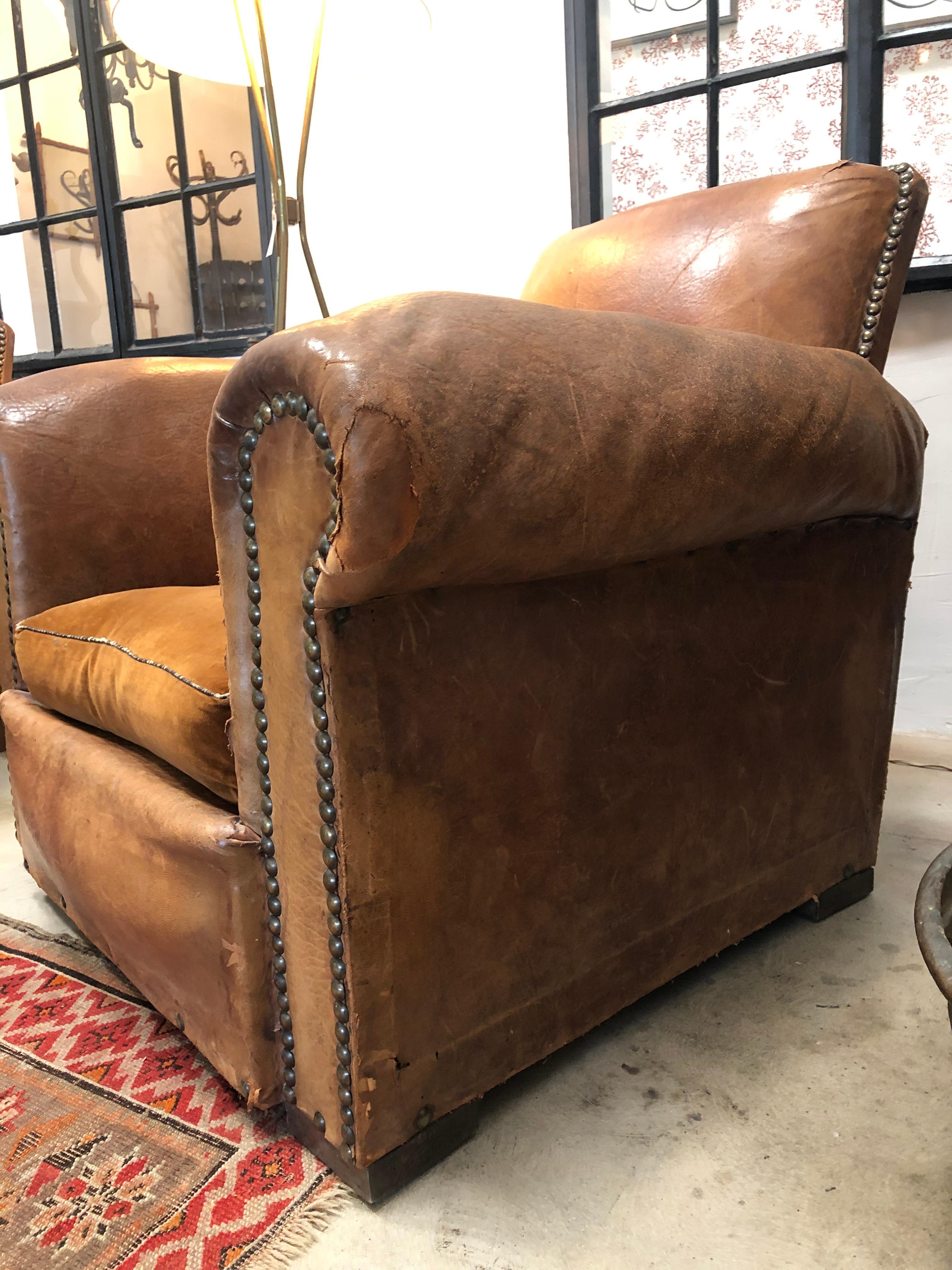 Vintage leather club chair, pair with velvet seats. Detailed with nail studding. Camel leather is soft and velvet cushion fluffed. This set is from the early 1900s between 1920-1940. A great pair of chairs for any space. Completely comfortable, no