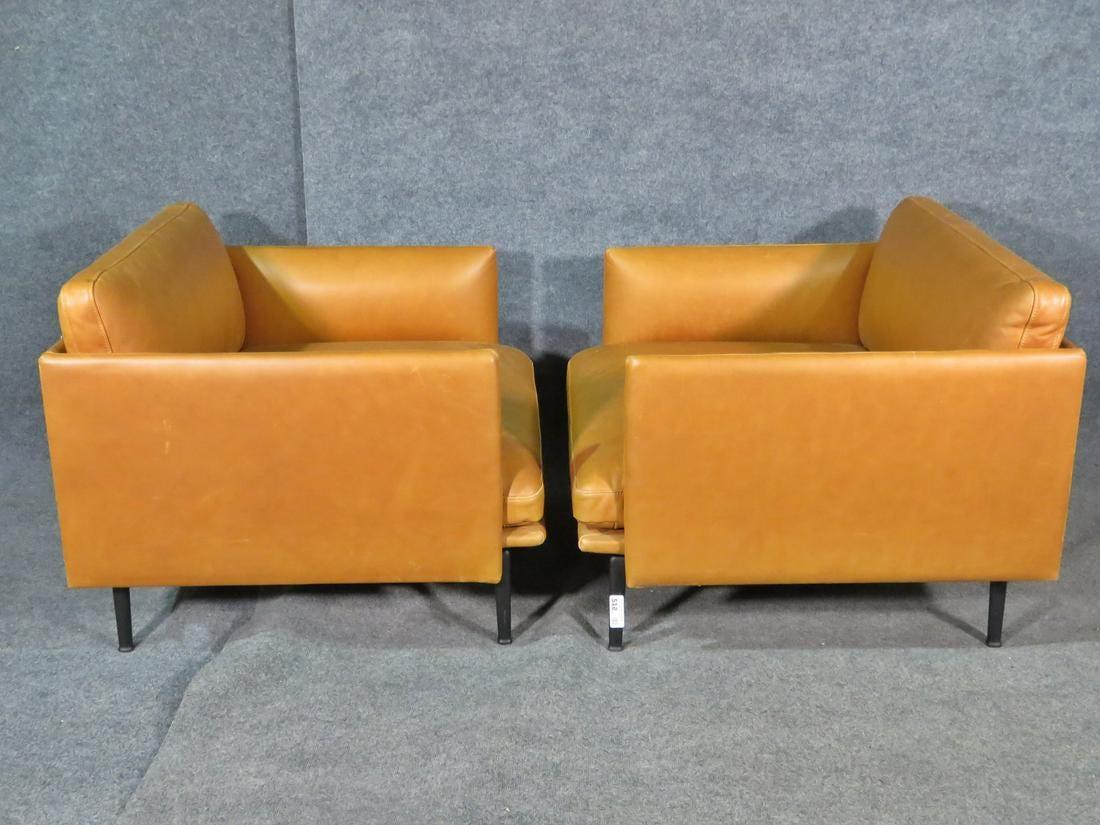 Upholstered in a vibrant golden yellow leather, this pair of vintage leather club chairs is a unique and bold statement in any setting. Comfortably cushioned with roomy seating, these chairs offer a stylish way to relax. Please confirm item location