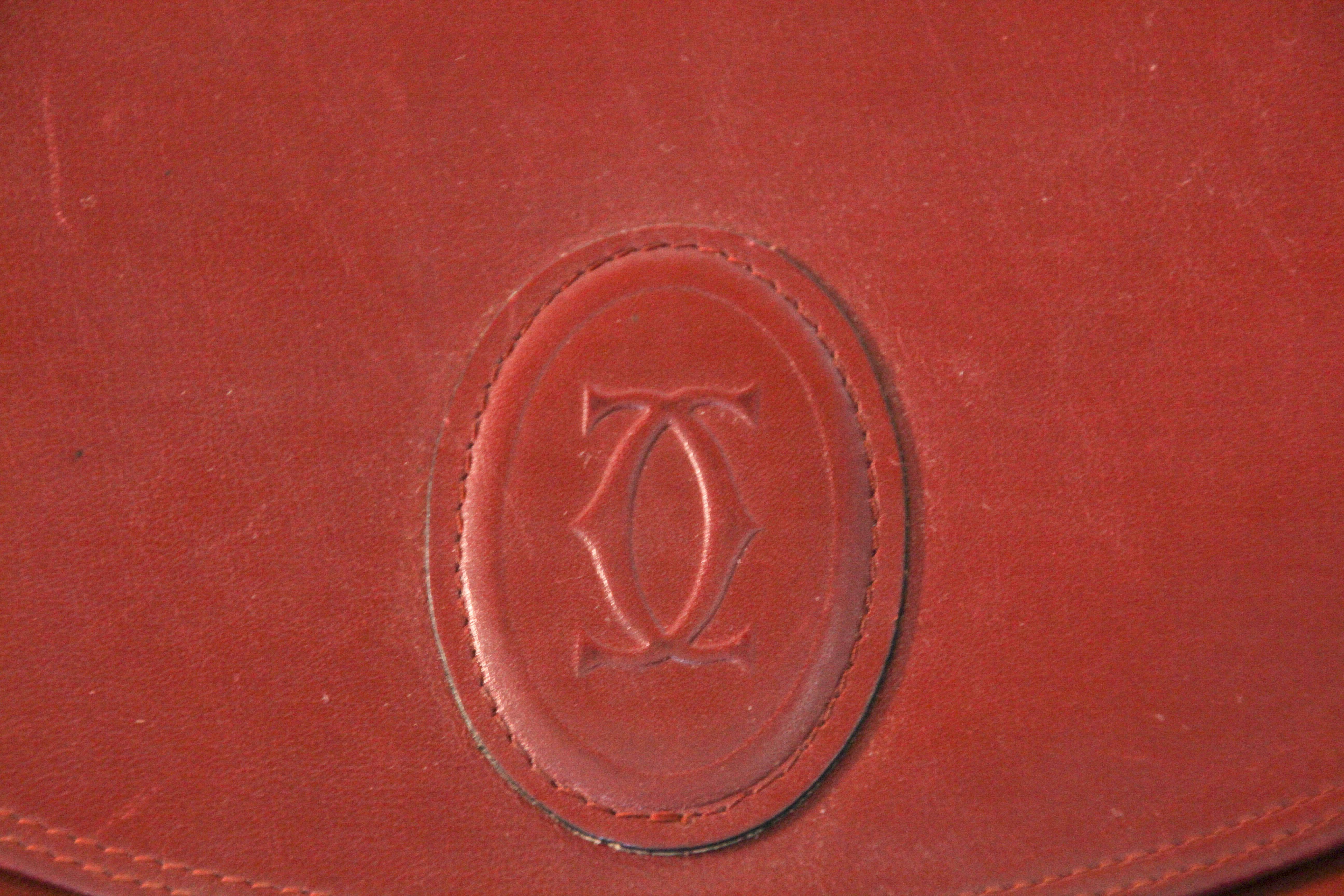 Vintage Cartier wine leather clutch bag, mini document purse with logo motif.
Rare 