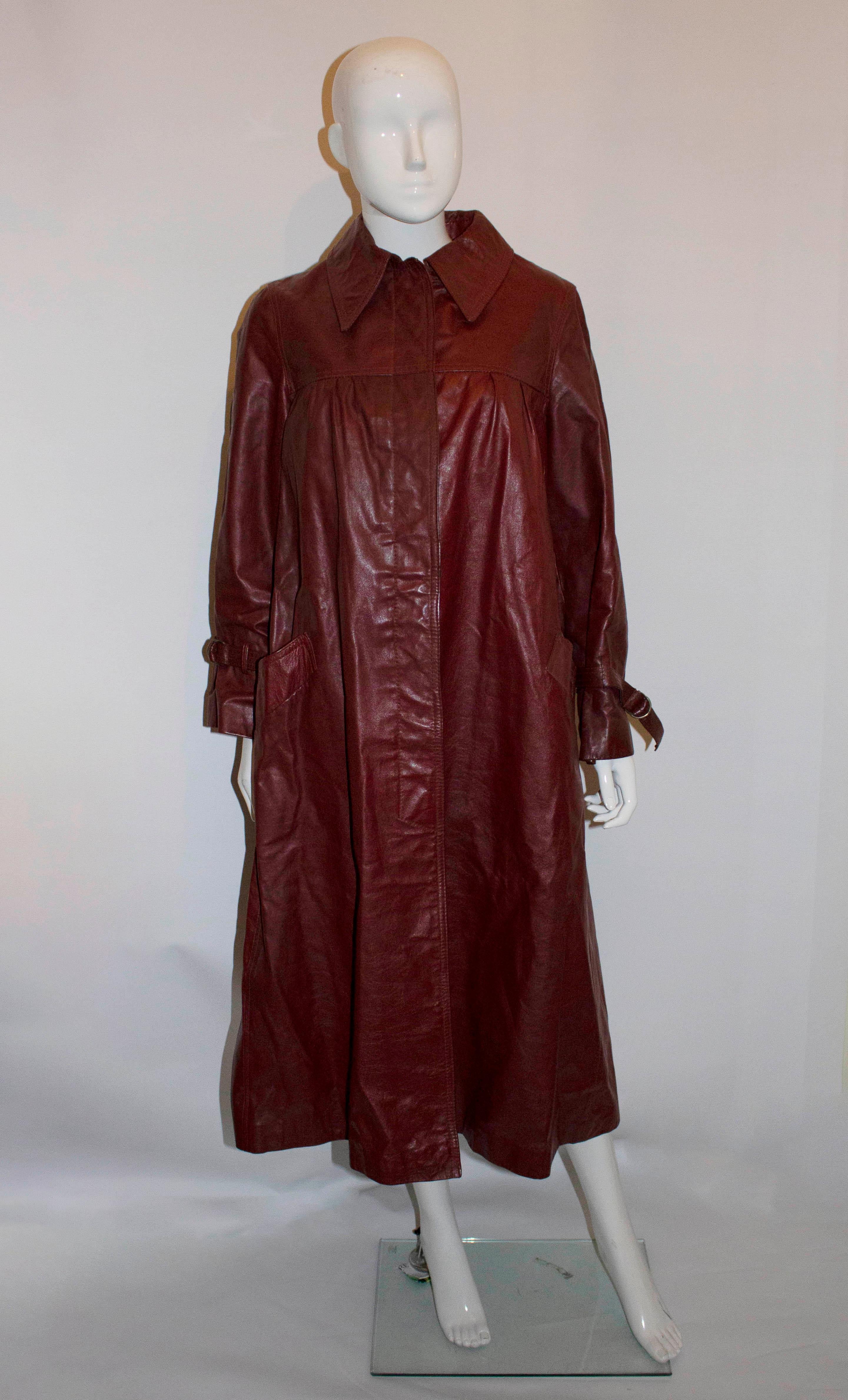 A stylish leather coat by BegedOr, styled in Isreal, made in England. In a burgundy/brown colour the coat has pleats at the yoke , a vent at the back , pockets at the front and is fully lined. 

Measurements: Bust up to 40'', length 47''