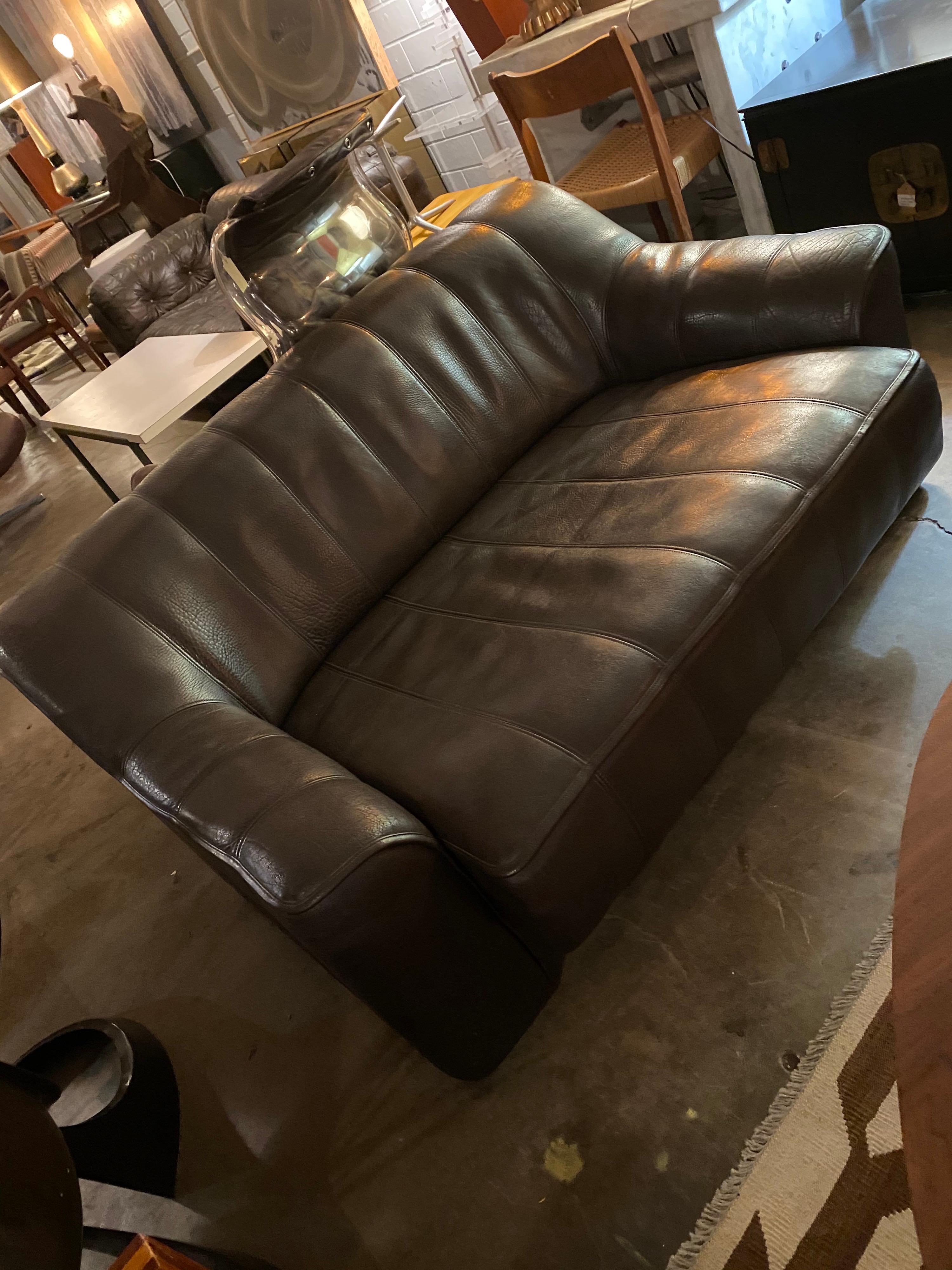 Made in Switzerland this stunning and incredibly comfortable mid-century De Sede sofa / love seat is made of buffalo leather. Dark mocha in color, the seat is adjustable extending by six inches making it deeper for extra comfort. The De Sede seating