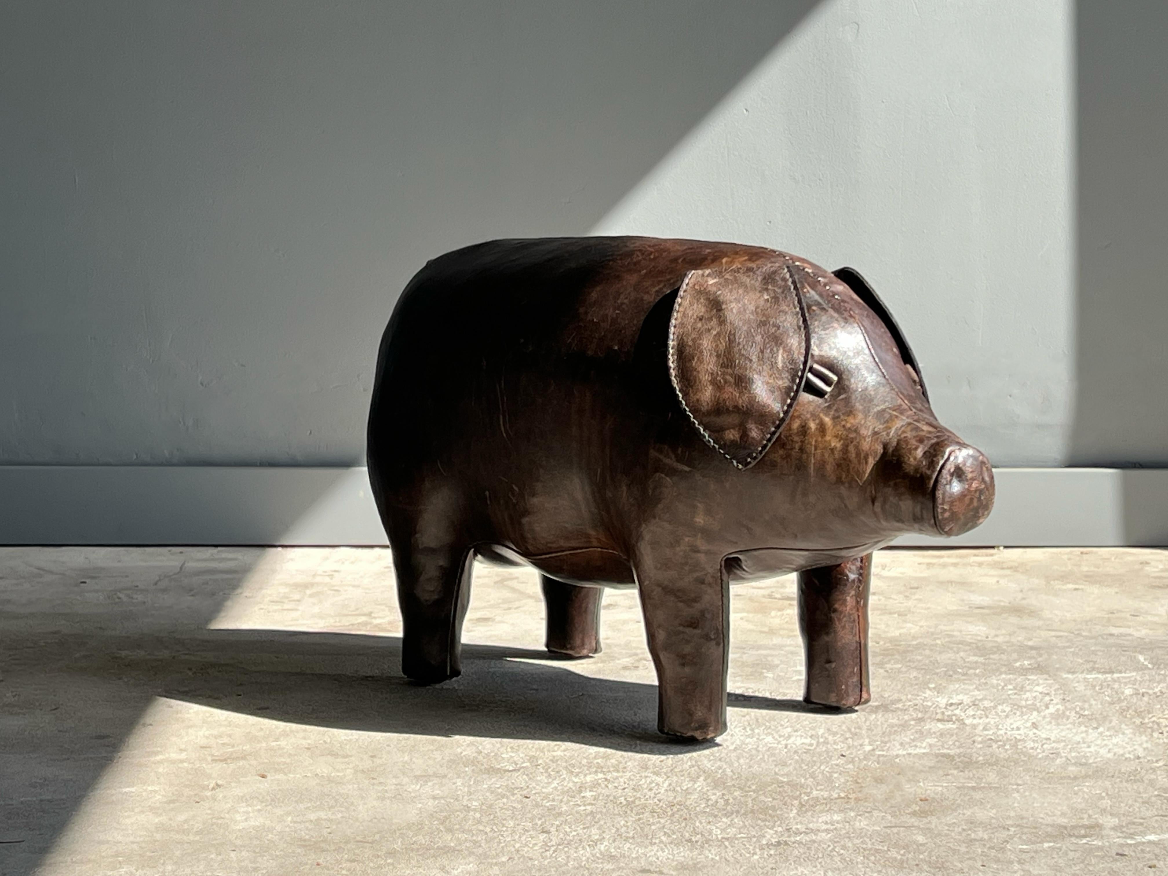 Wonderful leather stool or object by Dimitri Omersa for Abercrombie and Fitch. This pig is all hand stitched aged leather and shows and wonderful patina to its leather. No rips or tears.