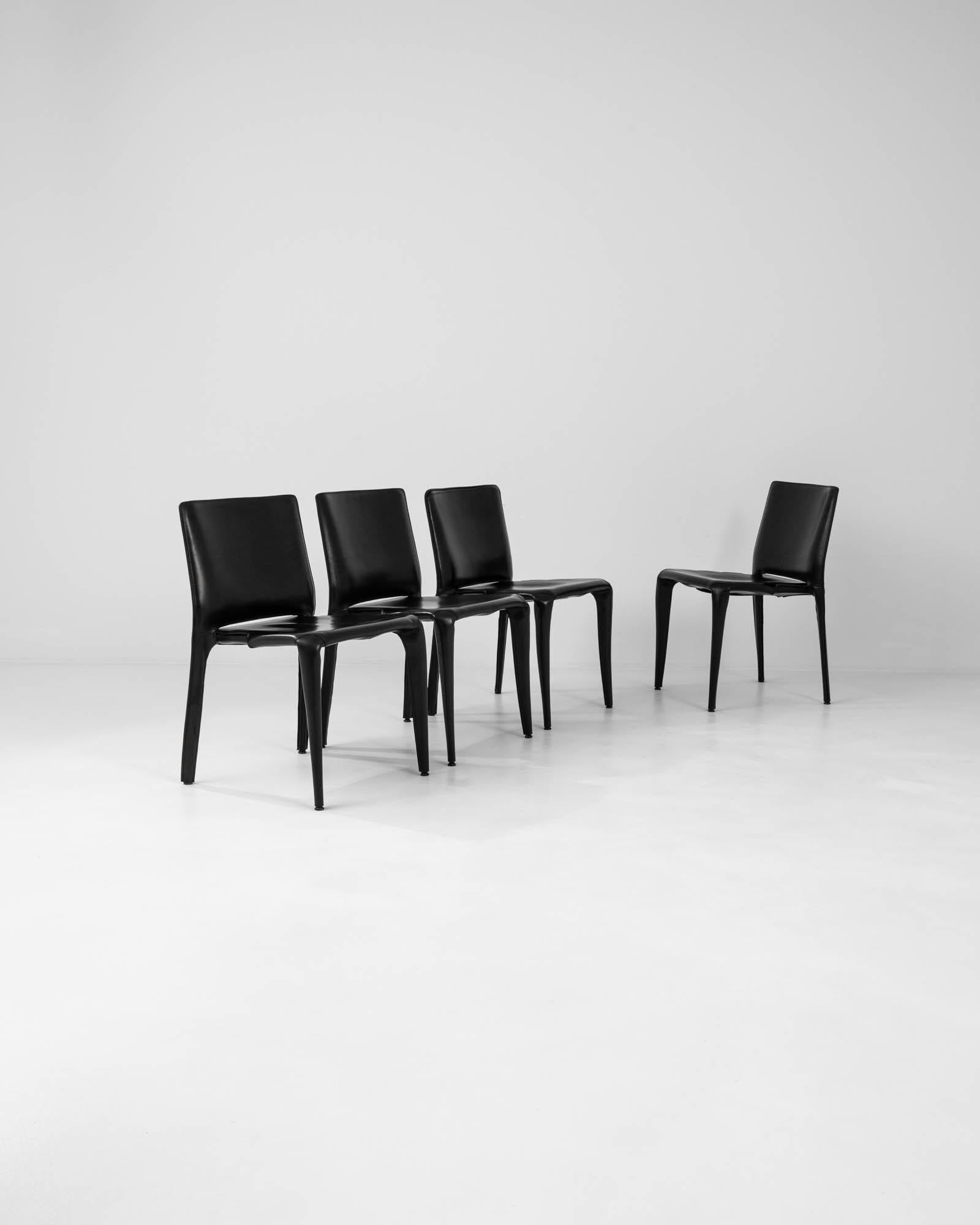 Presenting a unique character, these ‘Bull’ chairs by noted designer Mario Bellini serve equally by the dining table, or as visual accent pieces. Precisely stitched leather draws the material tight to provide a taut and neatly smooth surface. Sleek,