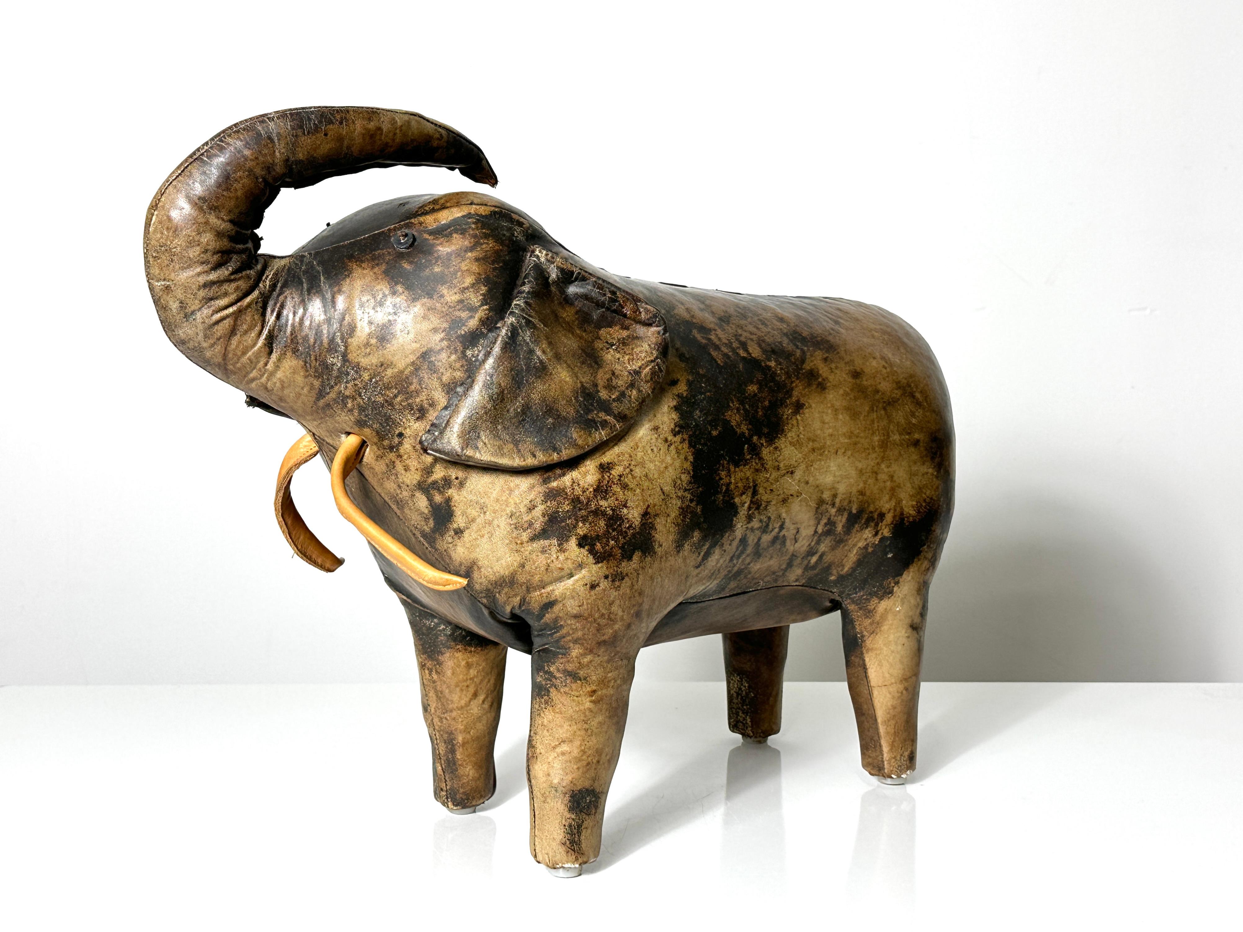 A leather elephant stool by Dimitri Omersa for Abercrombie & Fitch
Circa 1960s - 1970s

Hand stitched leather with floppy ears leather tusks and tassel tail
A unique example with really cool marbling and colors
Unmarked

21 inches wide
10 inches