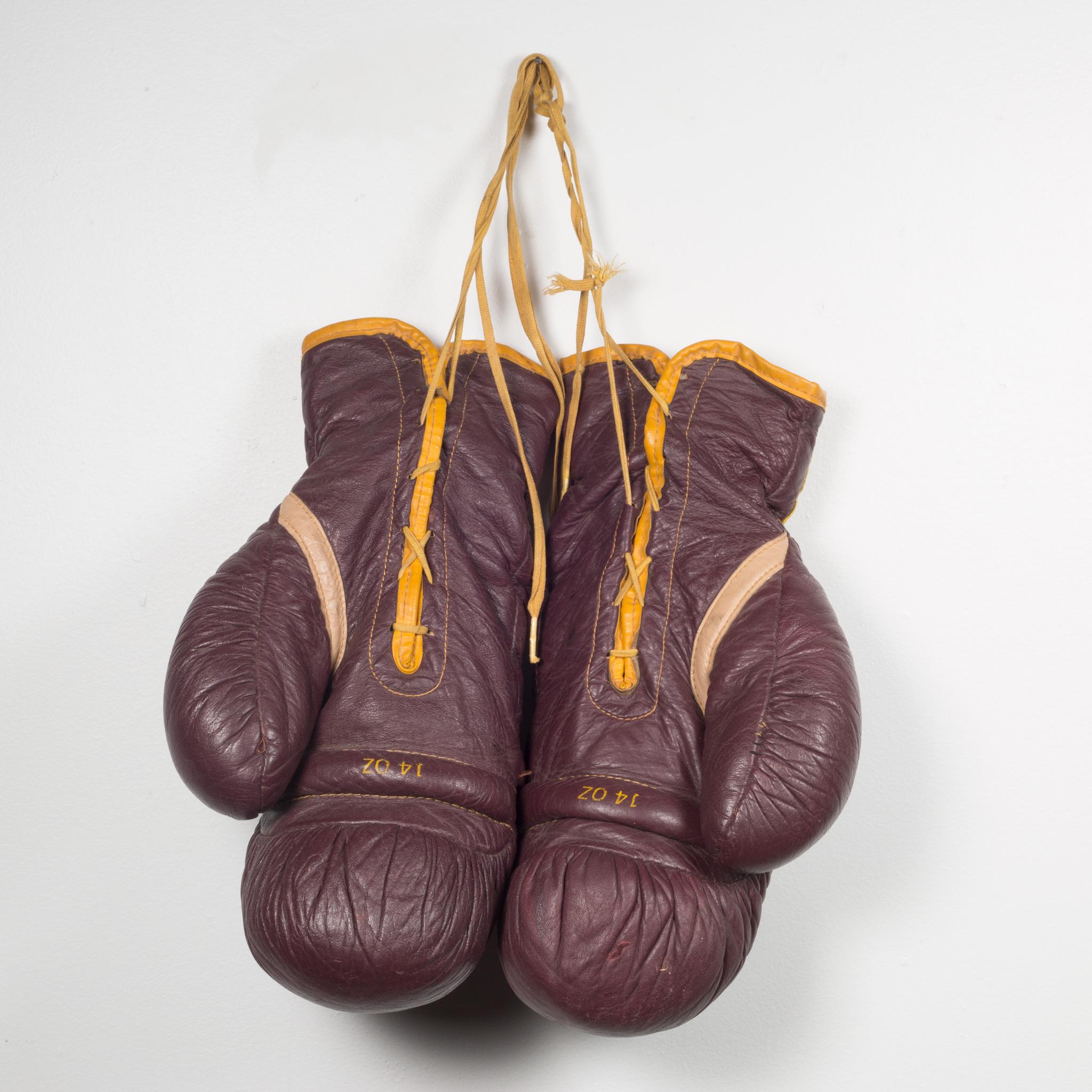 About

This is a original pair of Everlast leather boxing gloves. The boxing gloves are brown leather with gold leather piping, yellow laces and a leather 