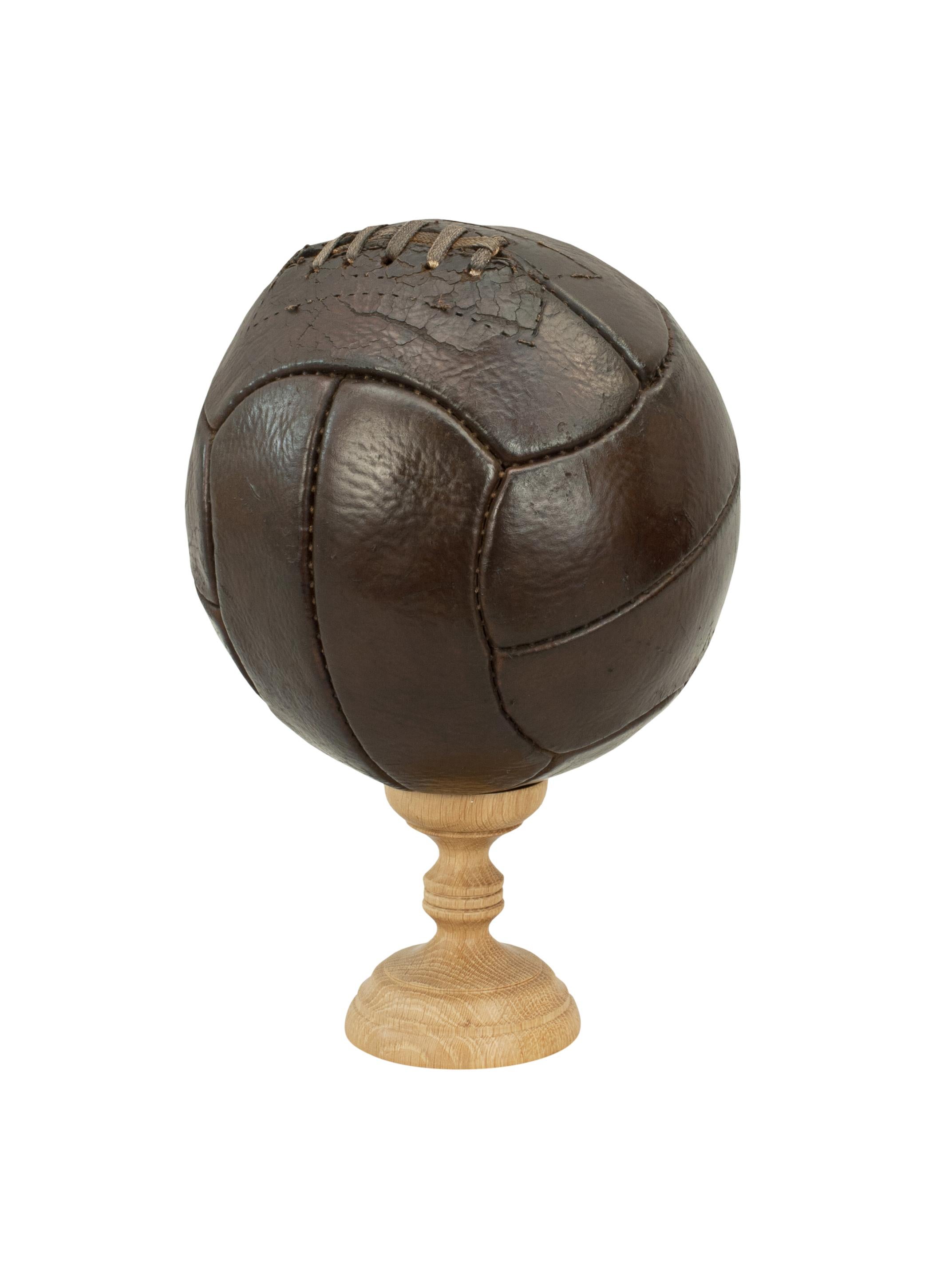Vintage leather football.
A traditional brown leather 12-panel soccer football in good condition. The ball has a lace-up slit to the top to enable bladder inflation.