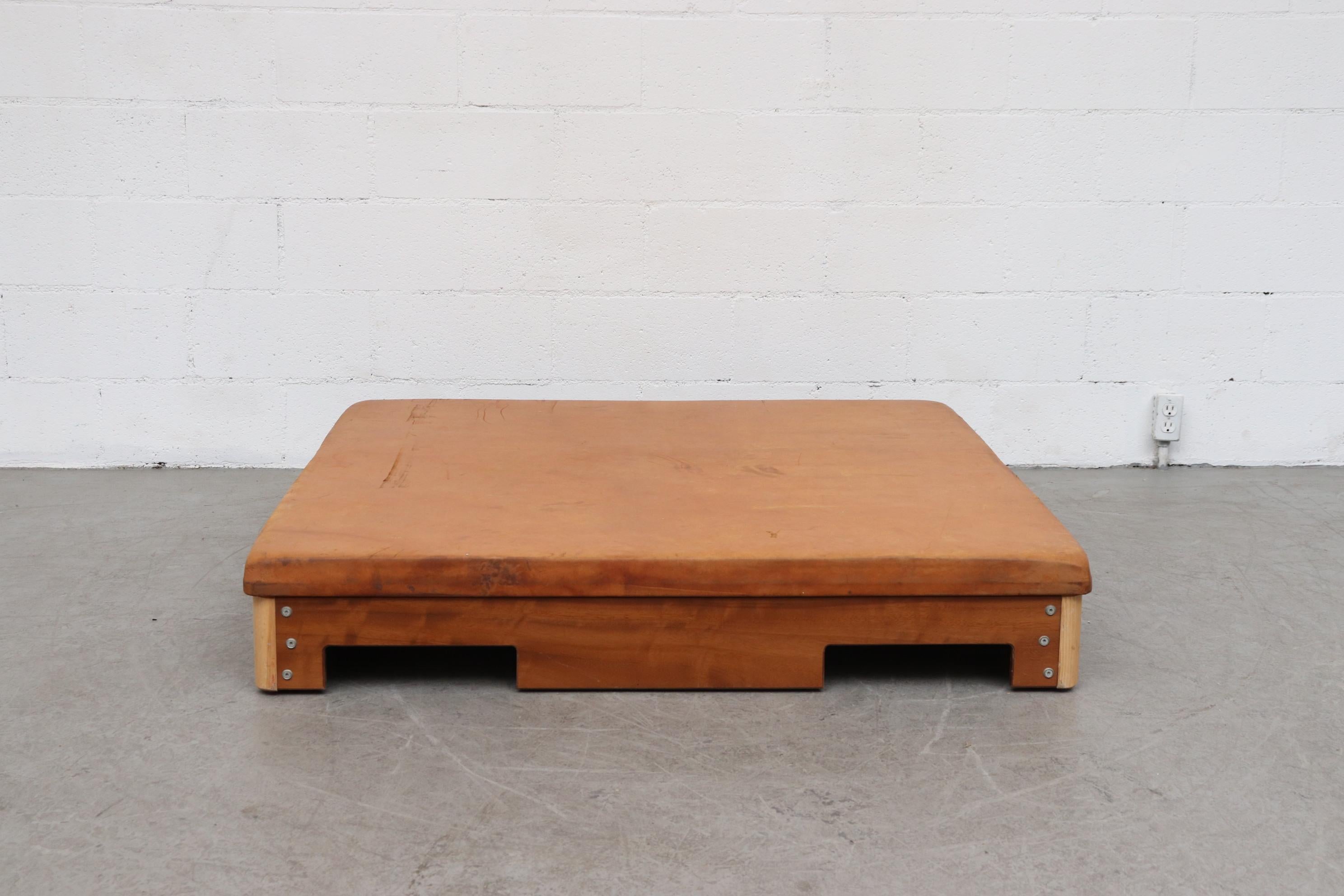 Square natural leather gym mat with heavy wooden frame. Perfect for a Zen lounge room, soft coffee table or twin sized headboard. In original condition with visible wear, some staining and nice patina. Well loved.