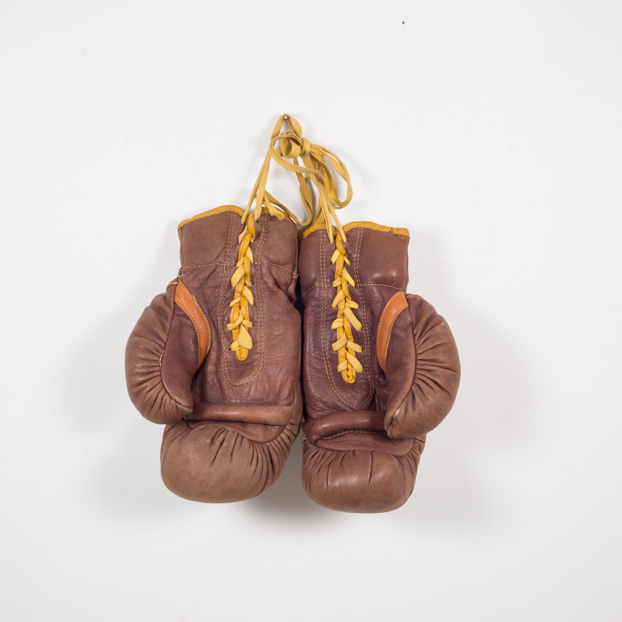 About

This is a original pair of vintage leather boxing gloves with brown and tobacco leather and gold piping and laces. Very thick gloves with manufacturers label on each glove.

 Creator: Ken Wel Sporting Goods Company, American 1919-1960.
