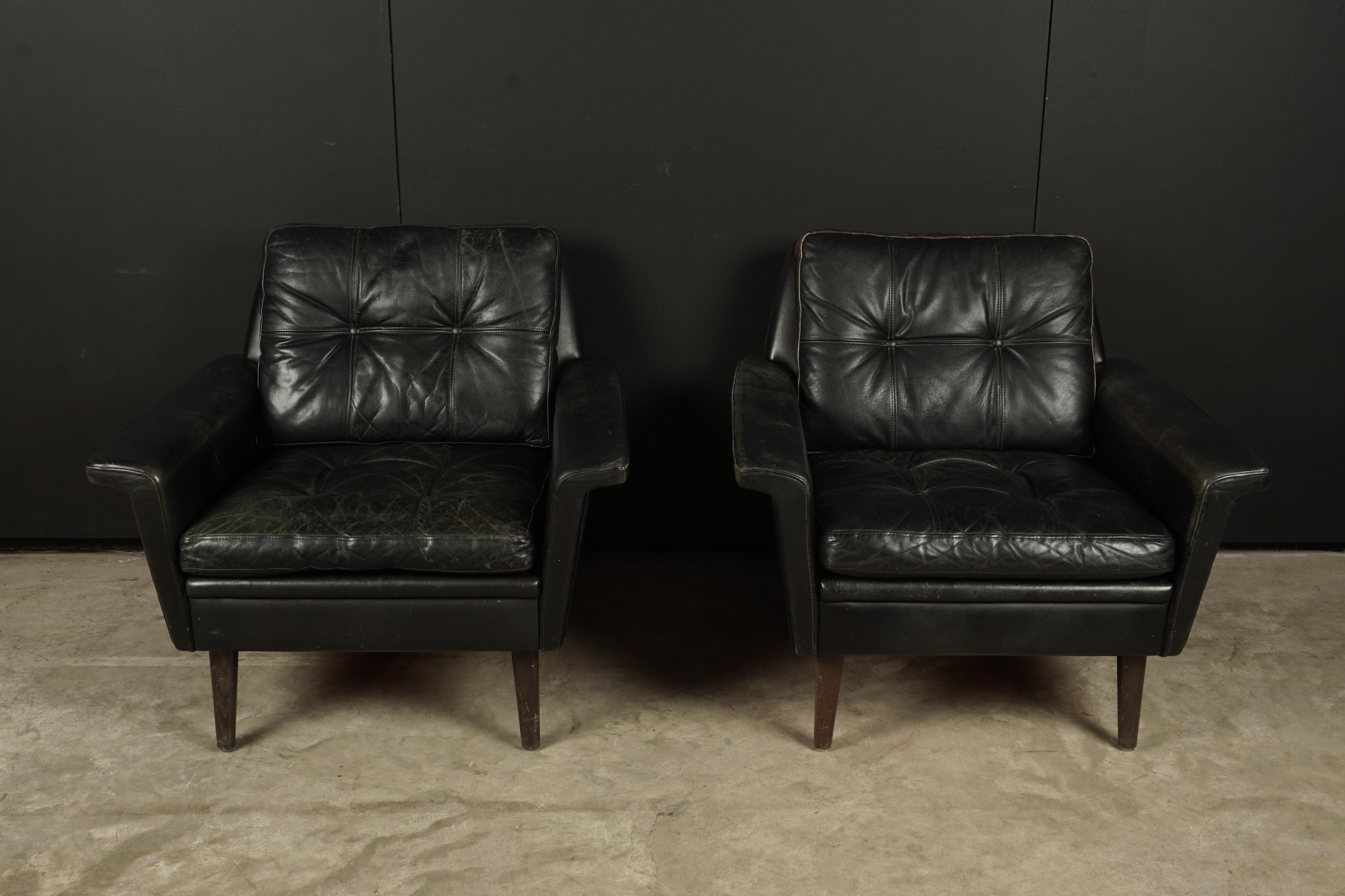 Vintage pair of leather lounge chairs from Denmark, circa 1970. Original black leather upholstery with light patina and wear.