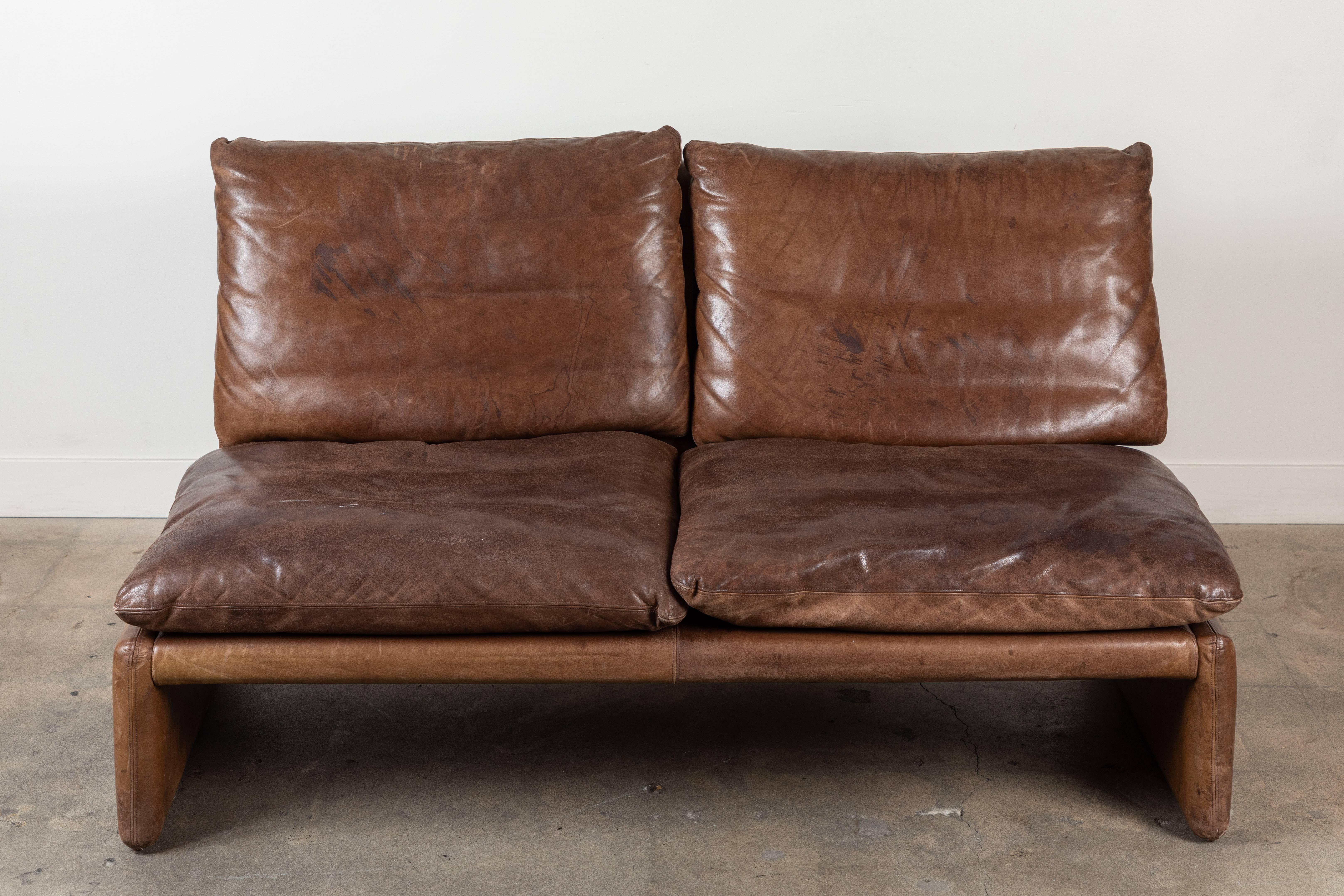 Vintage leather loveseat by COR Germany. Pair available.
