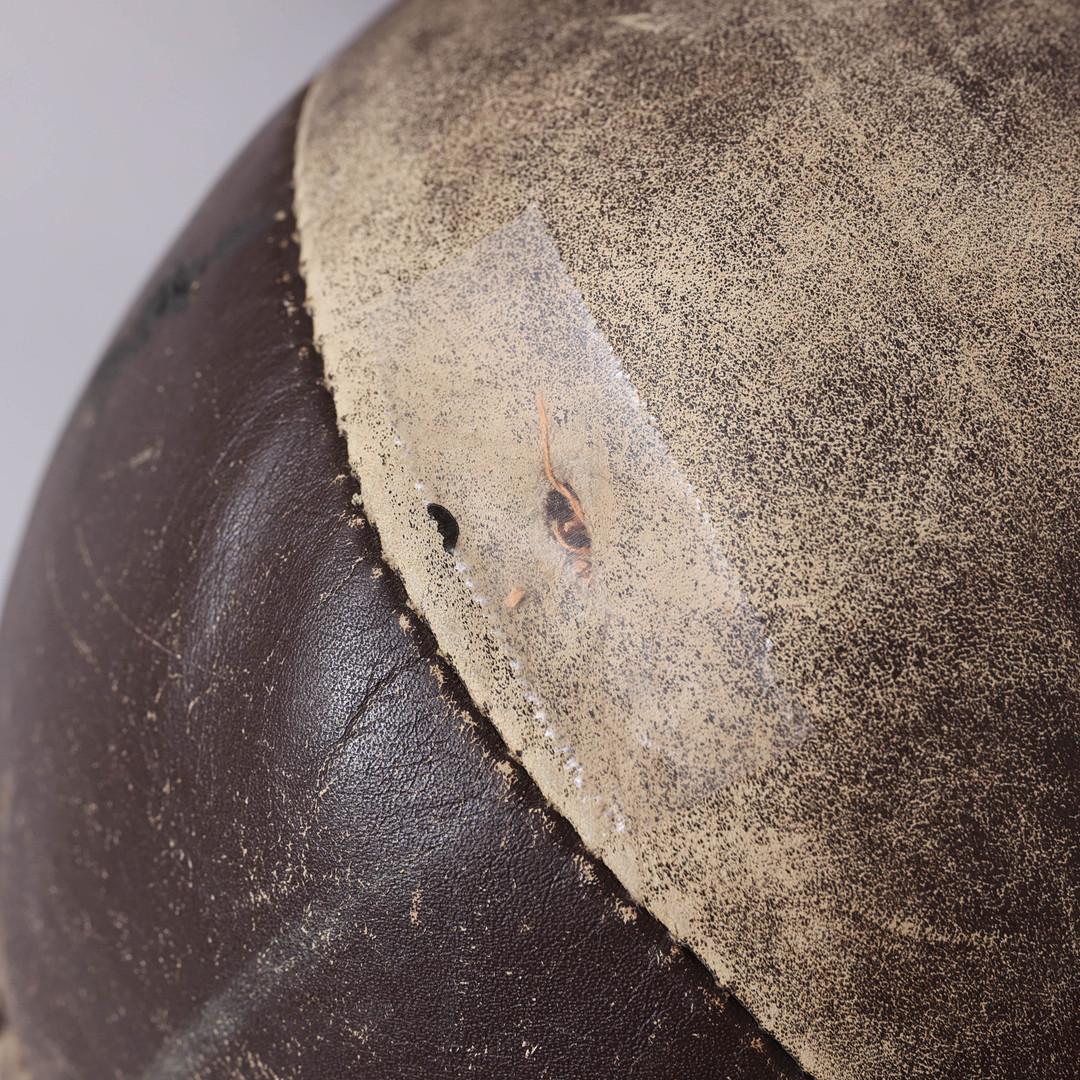 Original patinated leather medicine ball from the 1950s. A set of two.