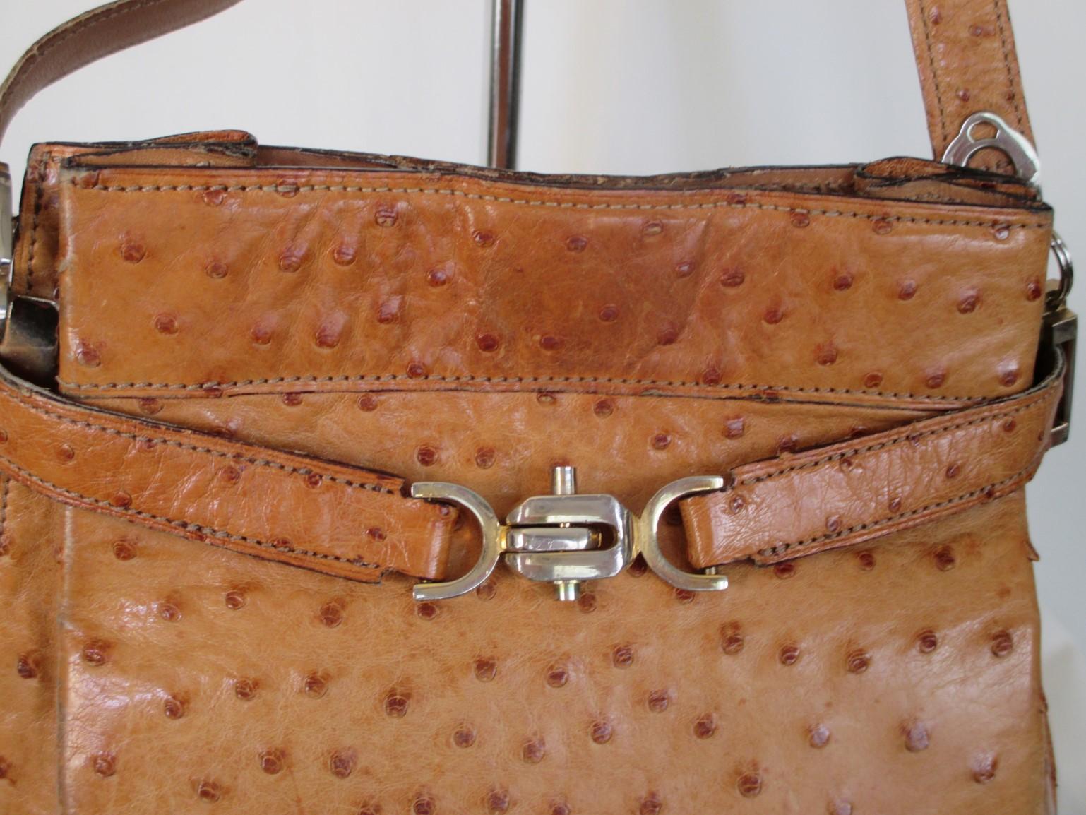 Rare vintage ostrich leather shoulder bag. 
This bag is made of cognac color ostrich leather with gold hardware and a front closure.
The lining is leather has 1 zip pocket and closes with a push-button inside.
This bag is worn and have some spots on