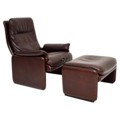 Used Leather Reclining Armchair and Stool by De Sede