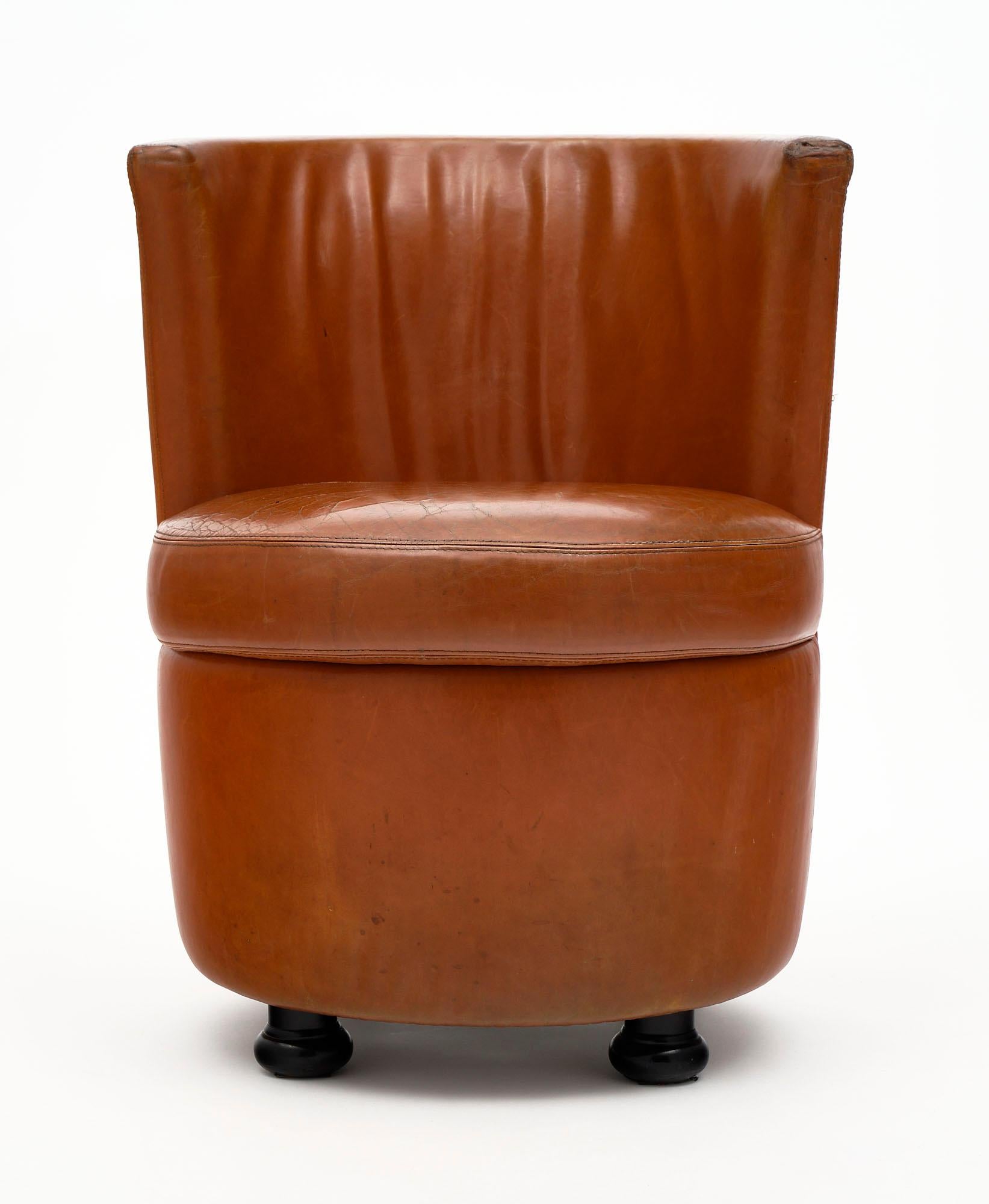 Side chair from Milan, Italy featuring the original leather upholstery in vintage condition. There are no tears. This piece is supported by wooden feet. We have a stool available that can be paired with it as well; see last photo.