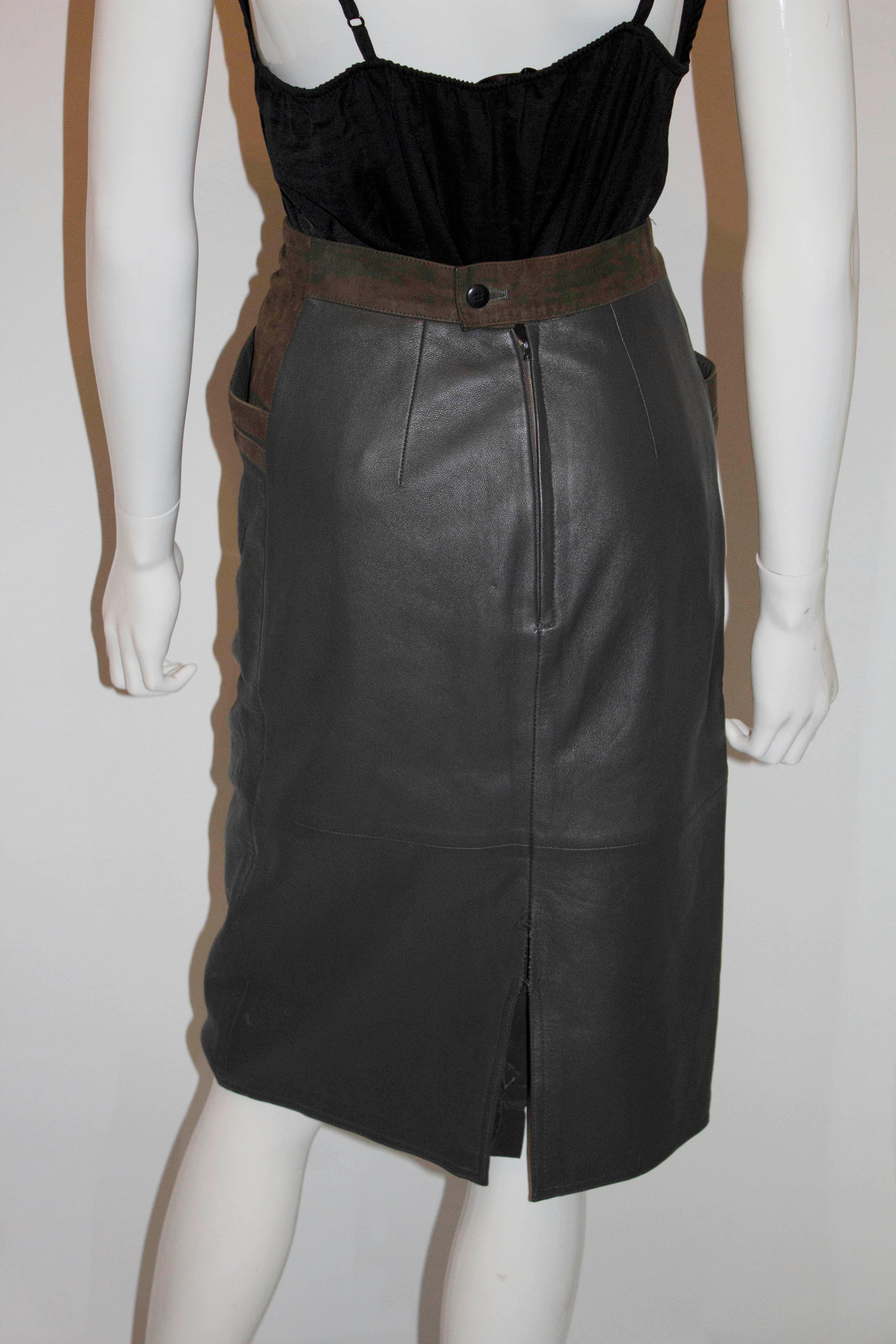 A chic vintage leather skirt in an attractive olive green colour with suede detail.  it has two pockets at the front and a central back zip opening. 
Measurements Size 42 waist 26'',length 27''