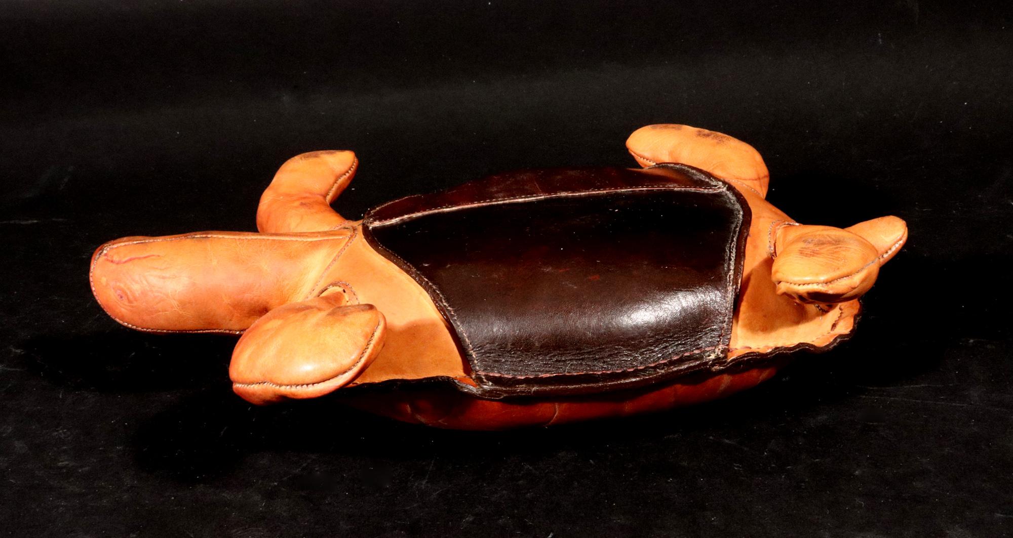 Vintage Leather Small Model of a Seal,
1960s-70s

The rare small leather model of a tortoise shows the outer shell with typical markings on the back.  The head has scored eyes and mouth .  The tail, four legs and head are a slightly lighter shade of