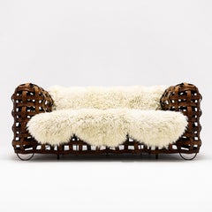 Vintage Leather strap sofa with upholstered seat and bespoke sheepskin throw