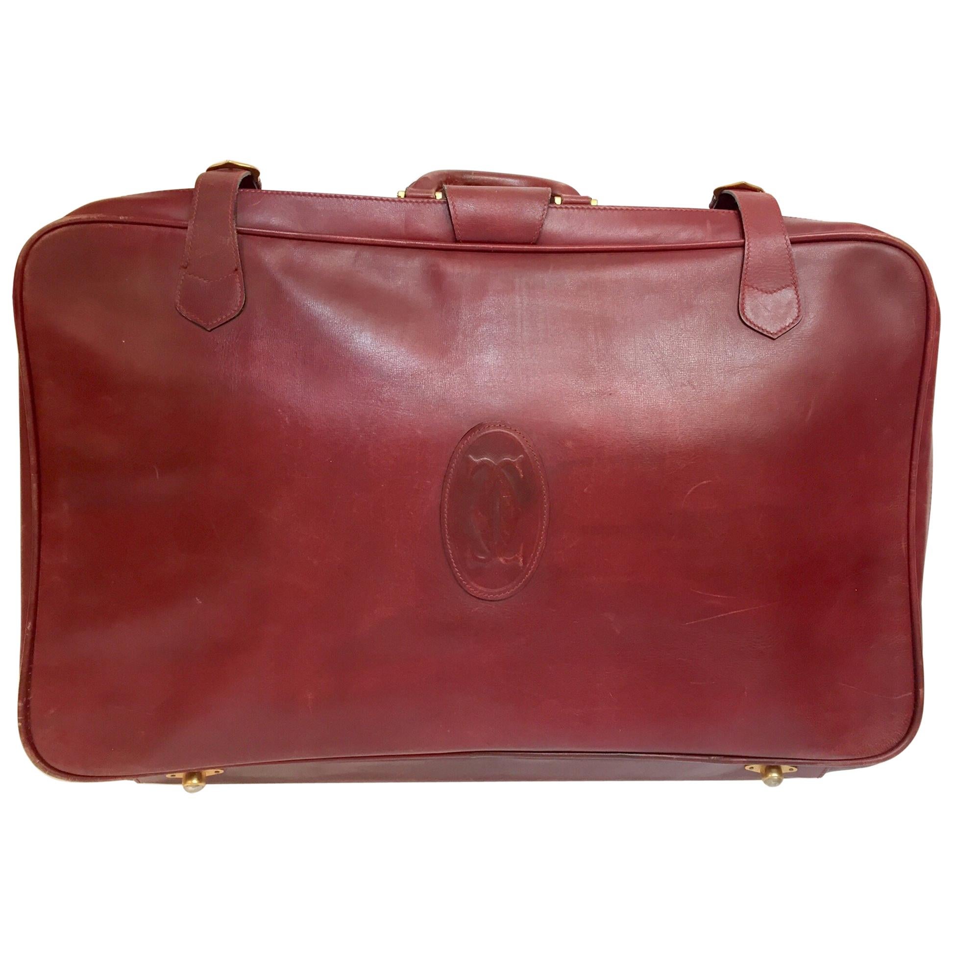 Valise en cuir vintage « Les Must de Cartier » bordeaux avec bagages