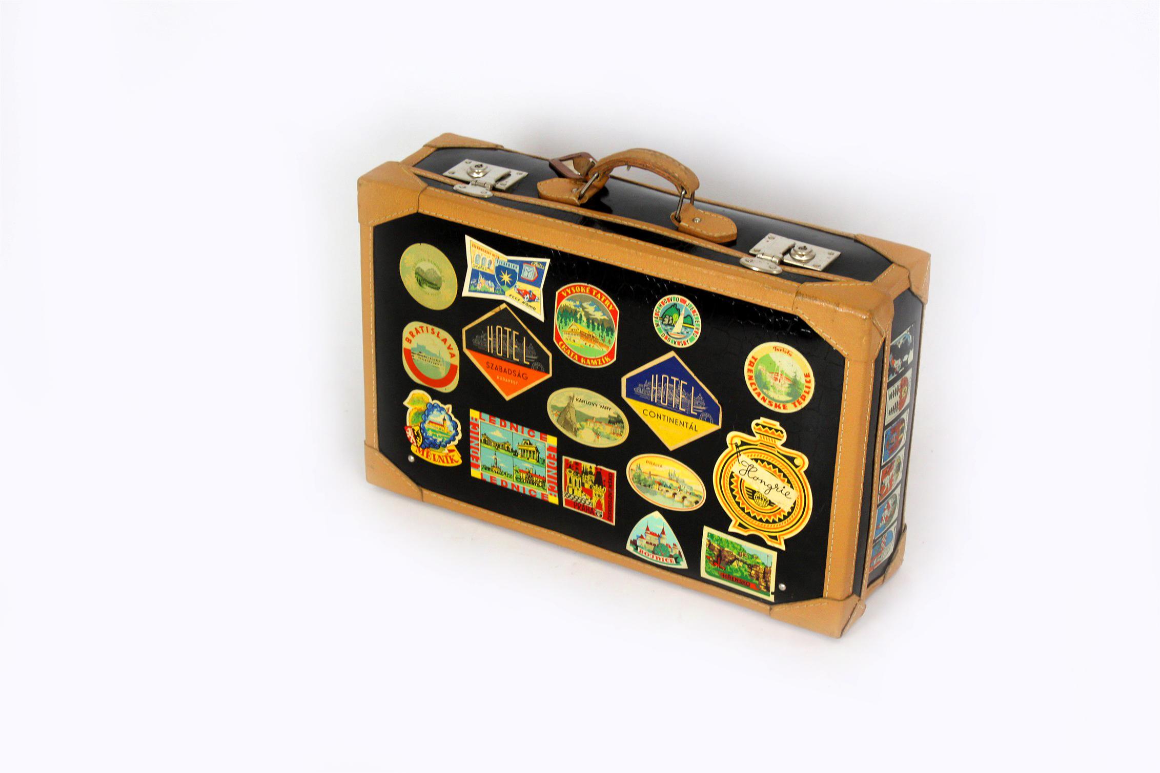 
This leather travel suitcase was produced in the Czech Republic in the 1950s. The suitcase is in very good condition with numerous original stickers, mainly from tourist places in Czechoslovakia.