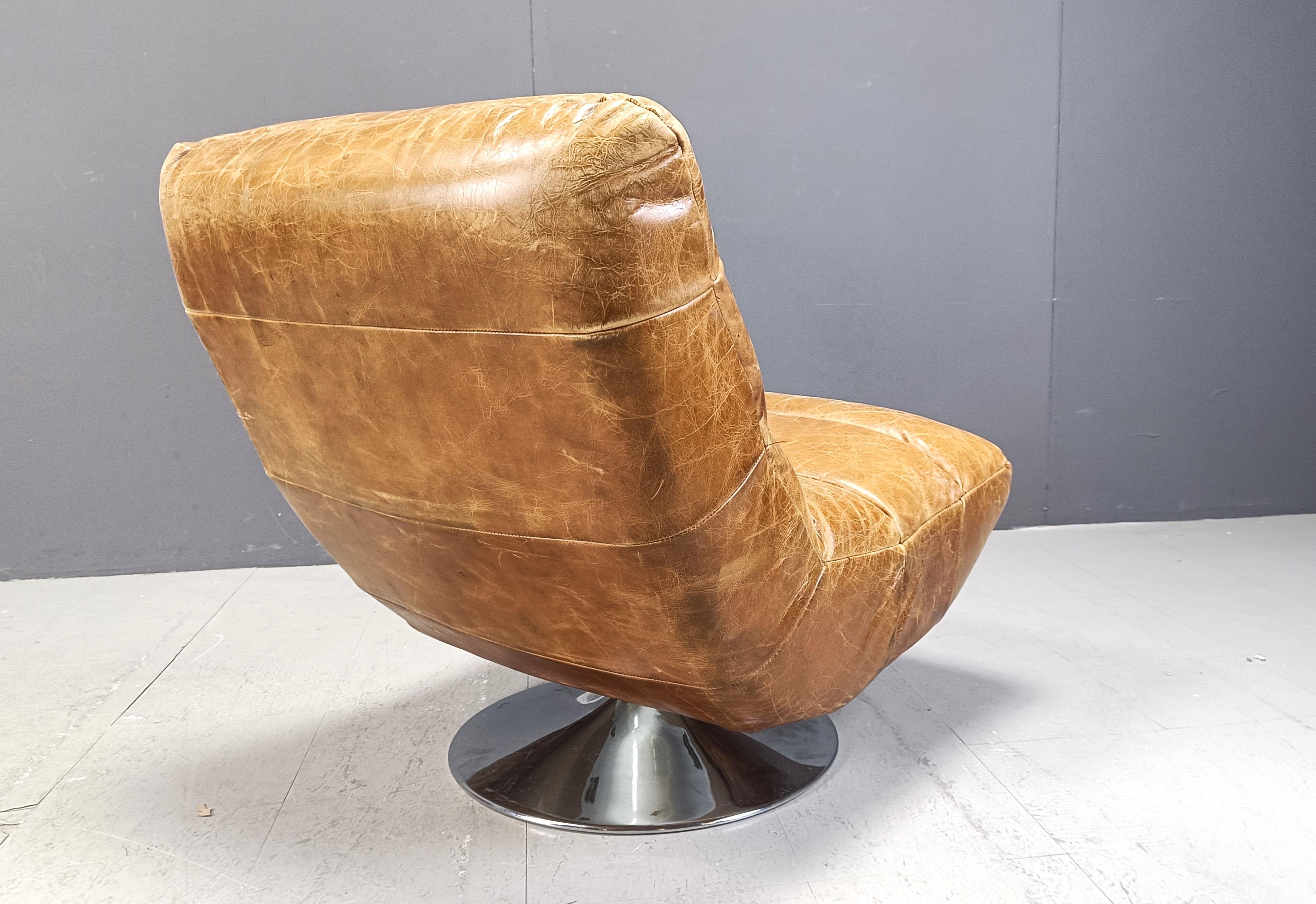 Vintage leather swivel chair with stool, 1970s For Sale 3