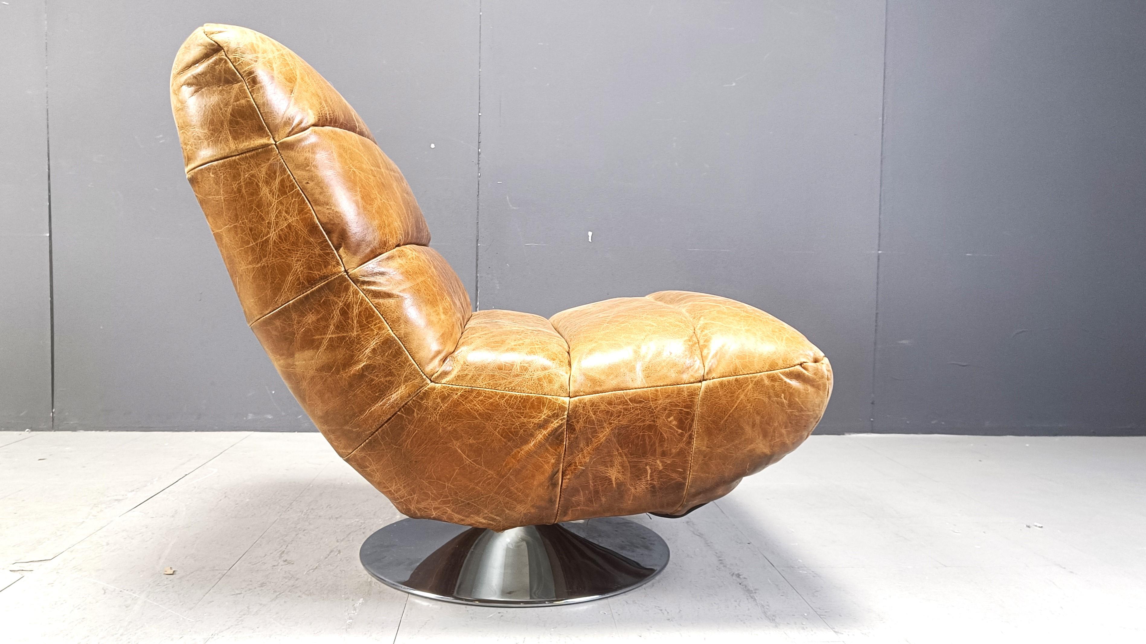 Vintage leather swivel chair with stool, 1970s For Sale 4